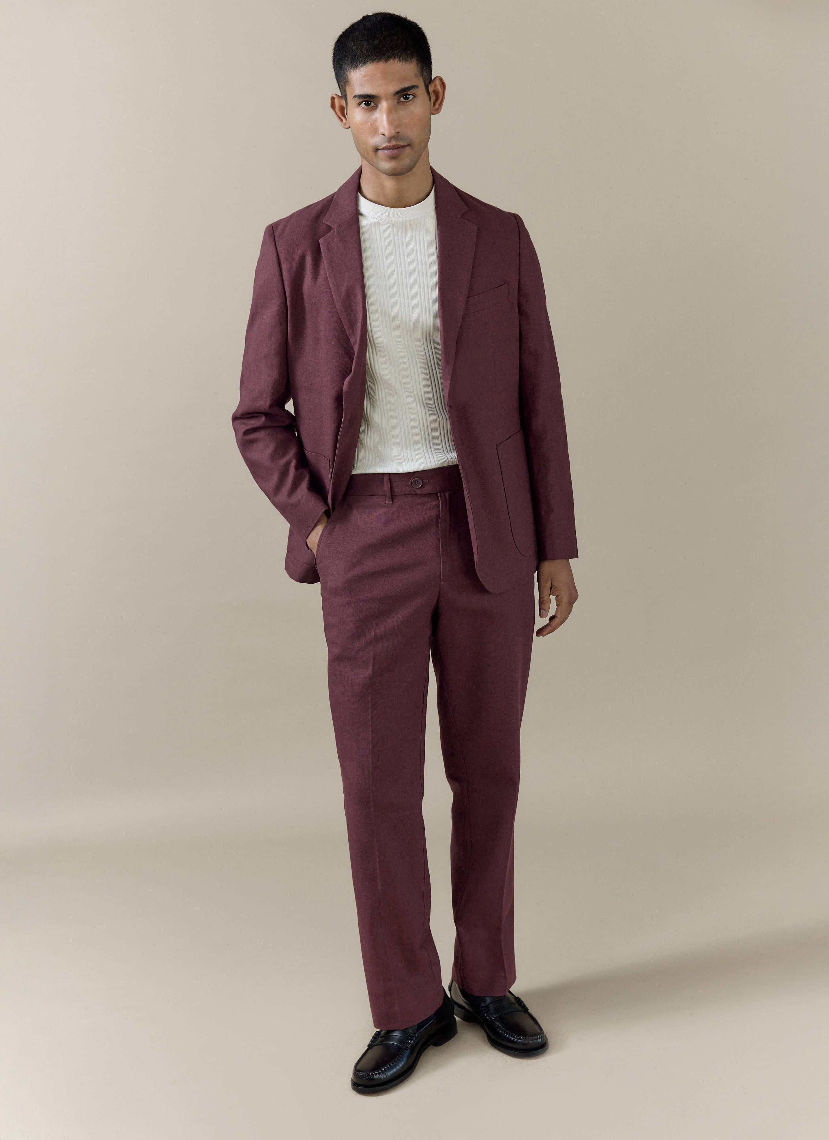 Percival tailored linen blazer in merlot, worn by a model with matching trousers and a white ribbed shirt.