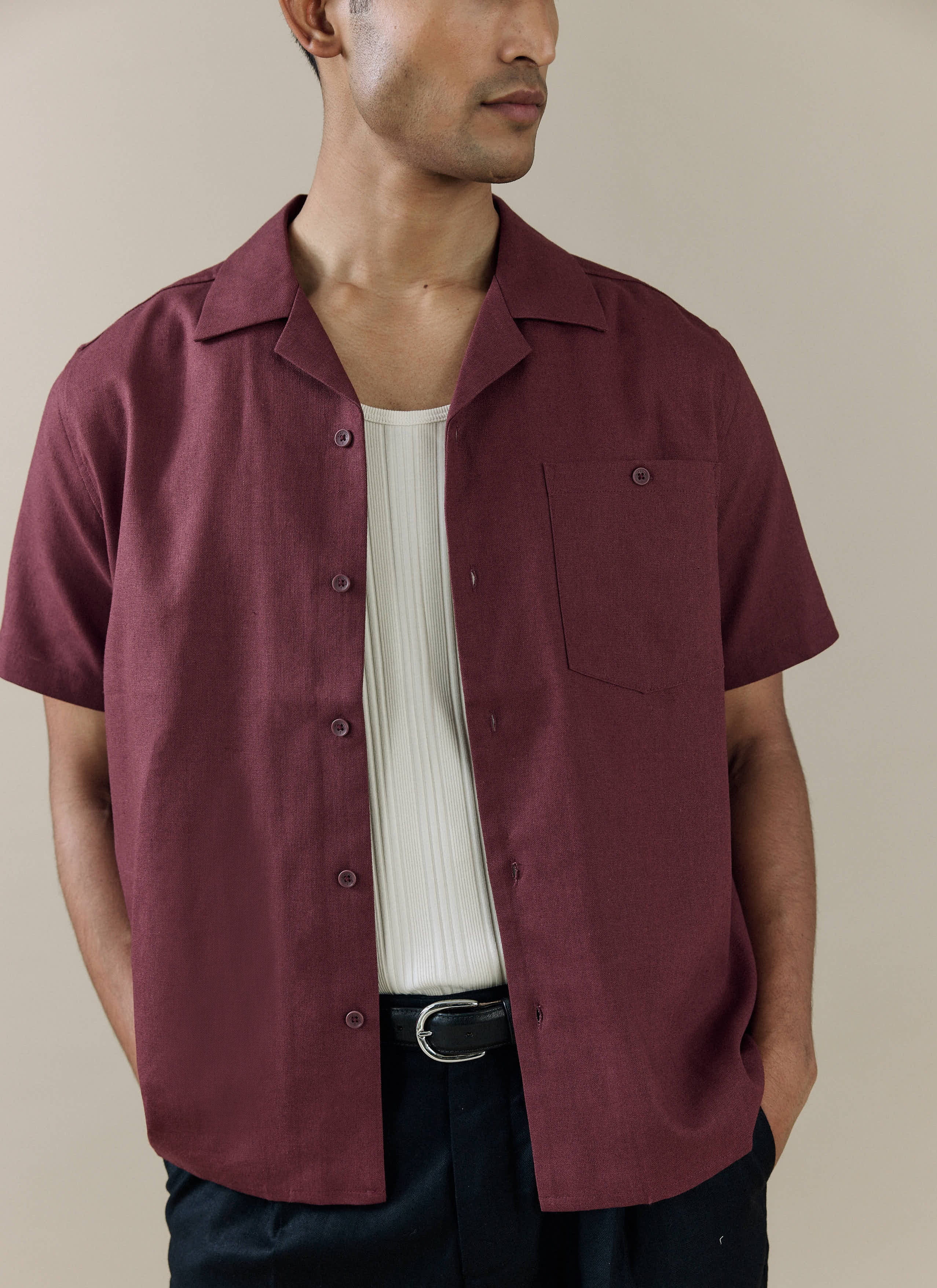 Percival Short Sleeve Cuban Shirt in merlot linen, worn open over a white rib vest with classic Cuban collar.