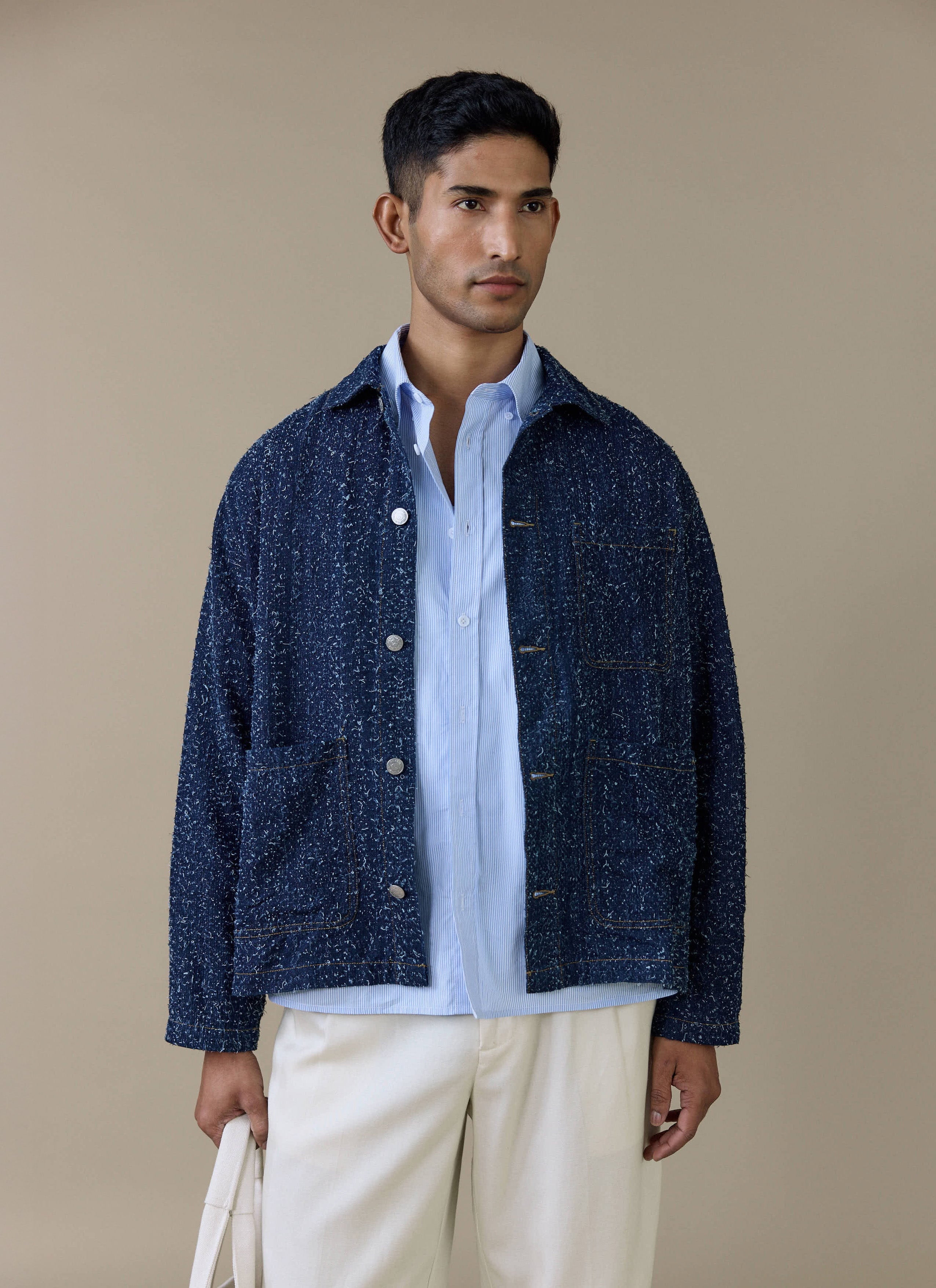 Model wearing the navy Parsons Chore Jacket by Percival, featuring silver press-stud buttons and front patch pockets.