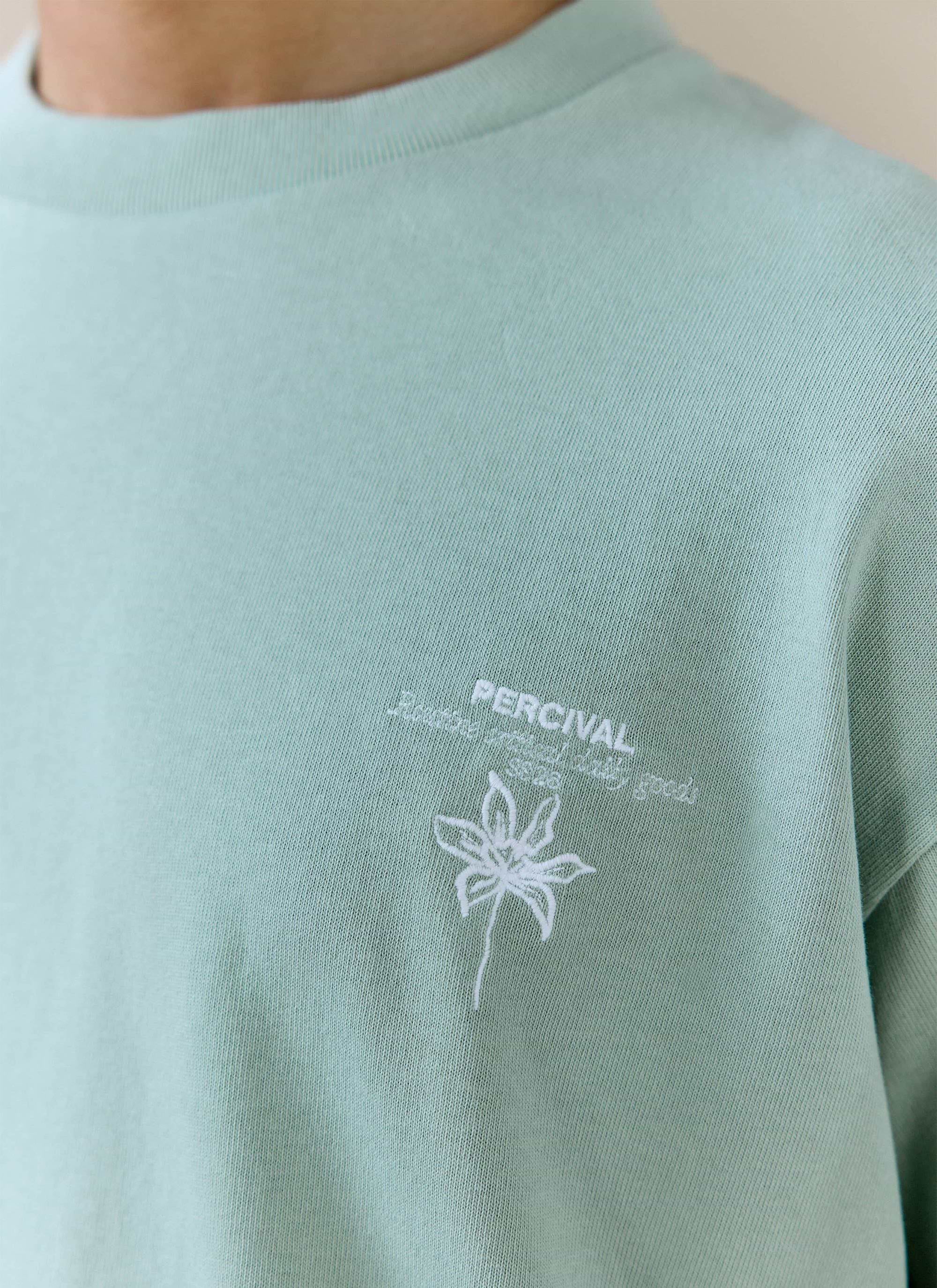 Sage green organic cotton Melvin Oversized T-shirt by Percival, featuring detailed white flower chest embroidery.