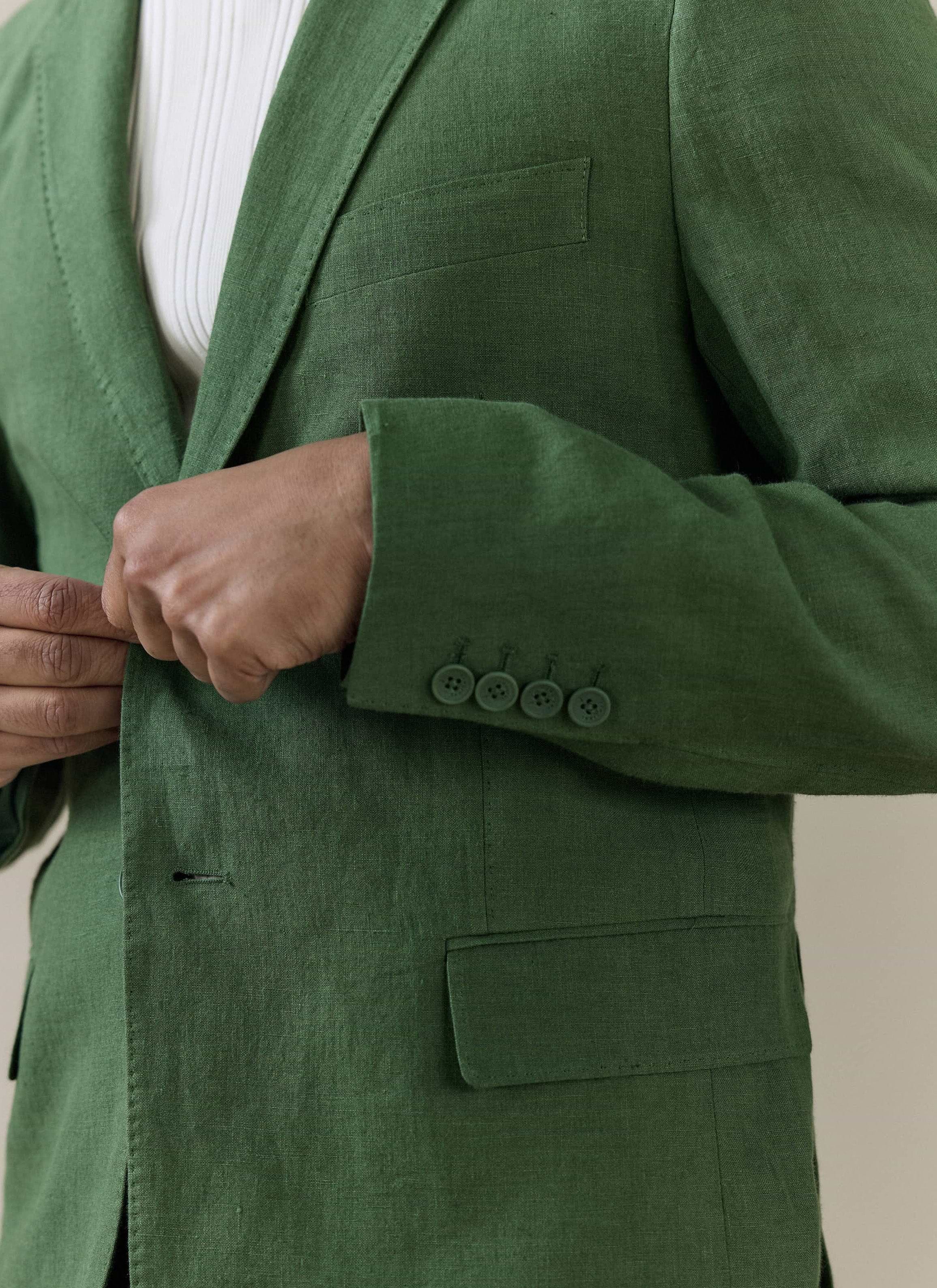 Close-up of the Percival Slim Fit Classic Blazer in forest green linen, showing the textured fabric and four-button cuff.