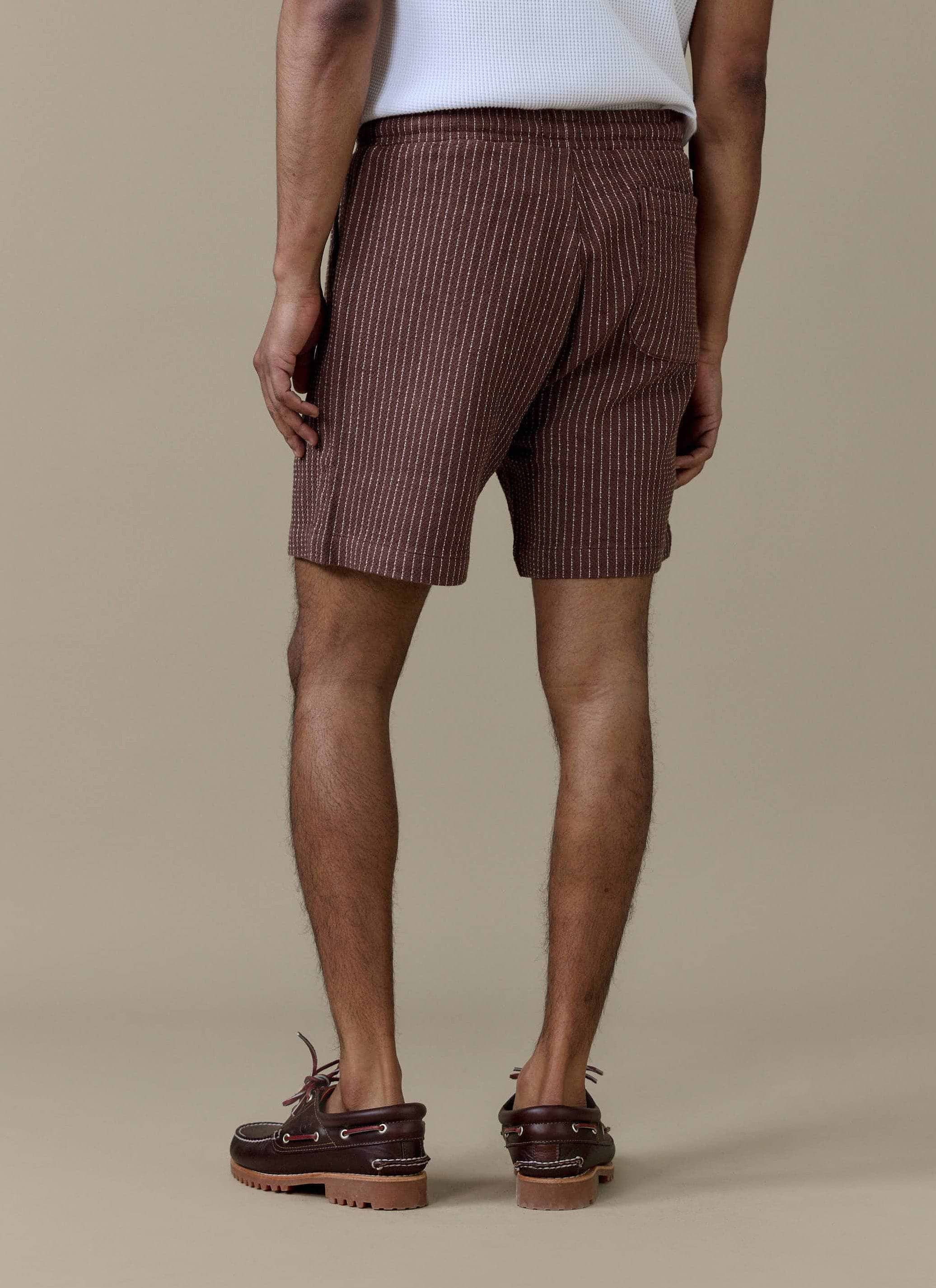 Rear view of the Percival Sorrento Linen Shorts in brown pinstripe, showing the back pocket and elasticated waistband.