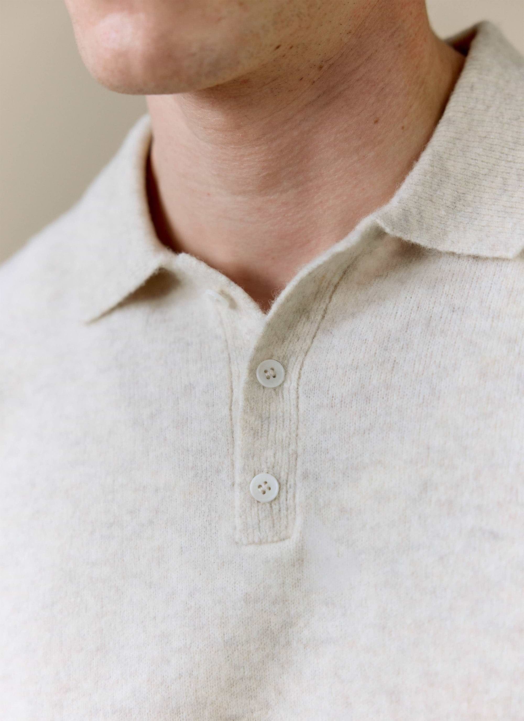 A close-up of the Percival Collins Boxy Knitted Polo in ecru, showing the soft yak-wool blend texture and two-button placket.