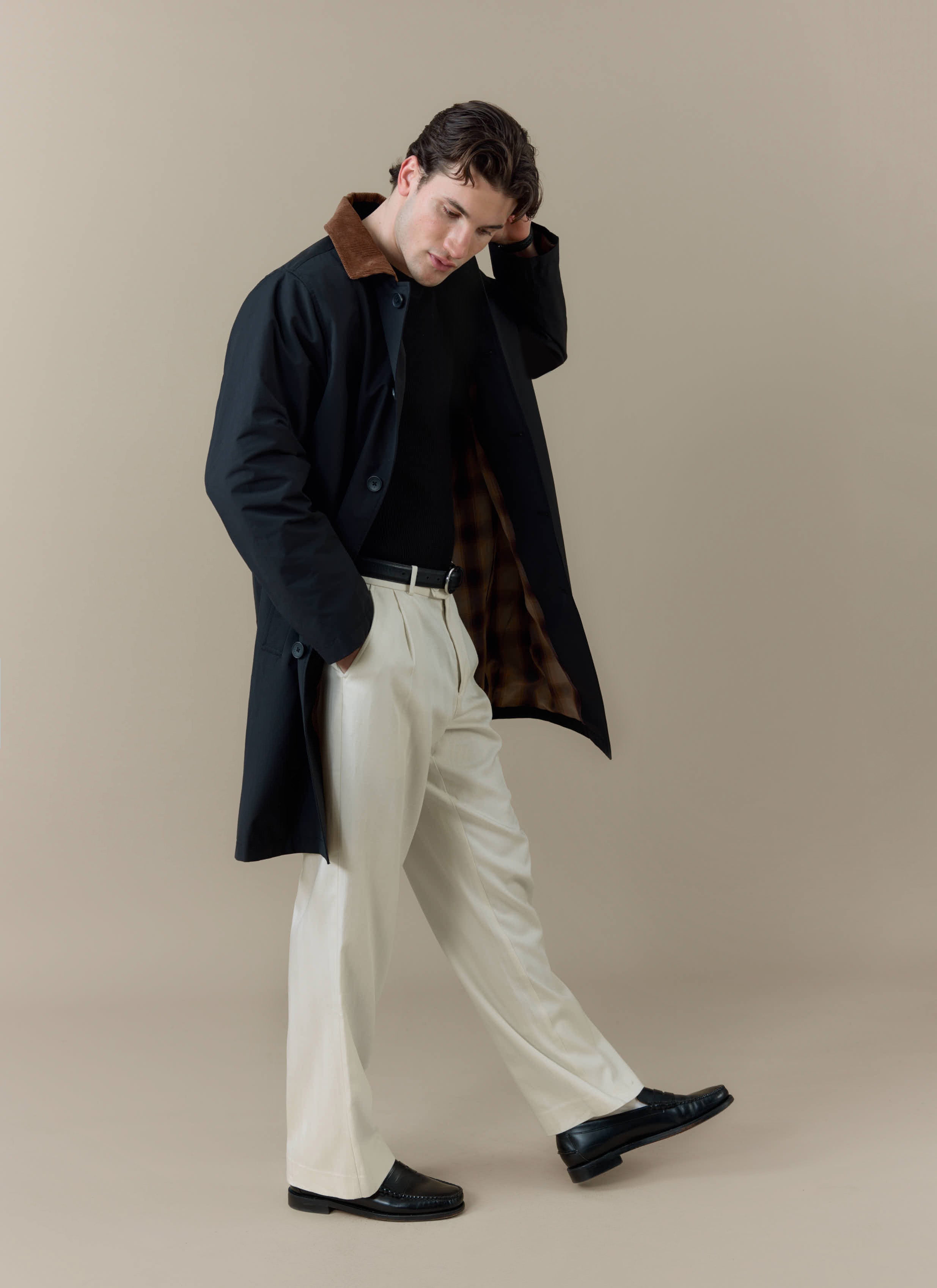 Model wears the black Percival Cord Collar Relaxed Trench Coat, showing the contrast corduroy collar and checked lining.