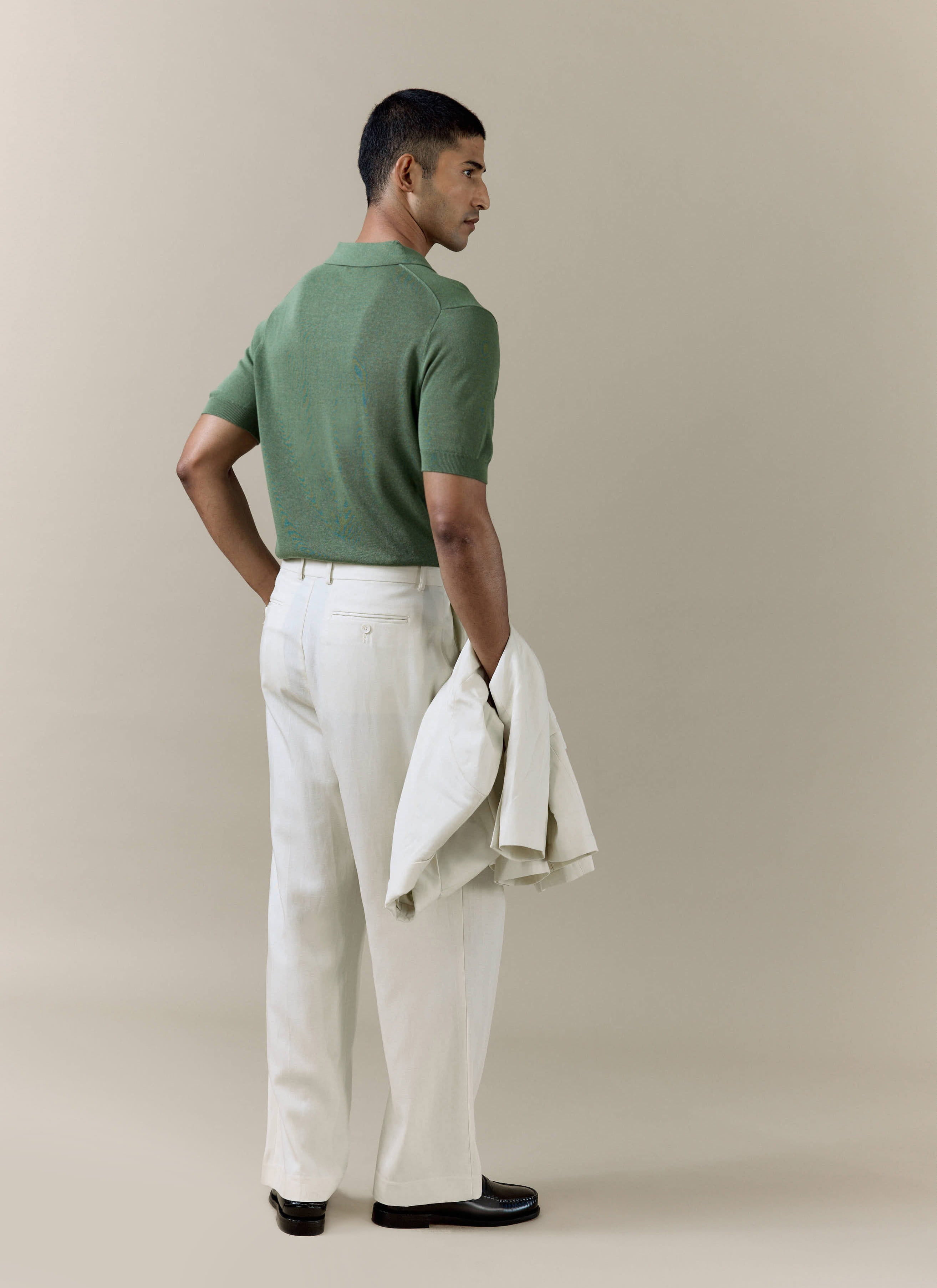 Percival Laurence knitted polo in forest green linen blend, styled with cream trousers and a matching jacket.