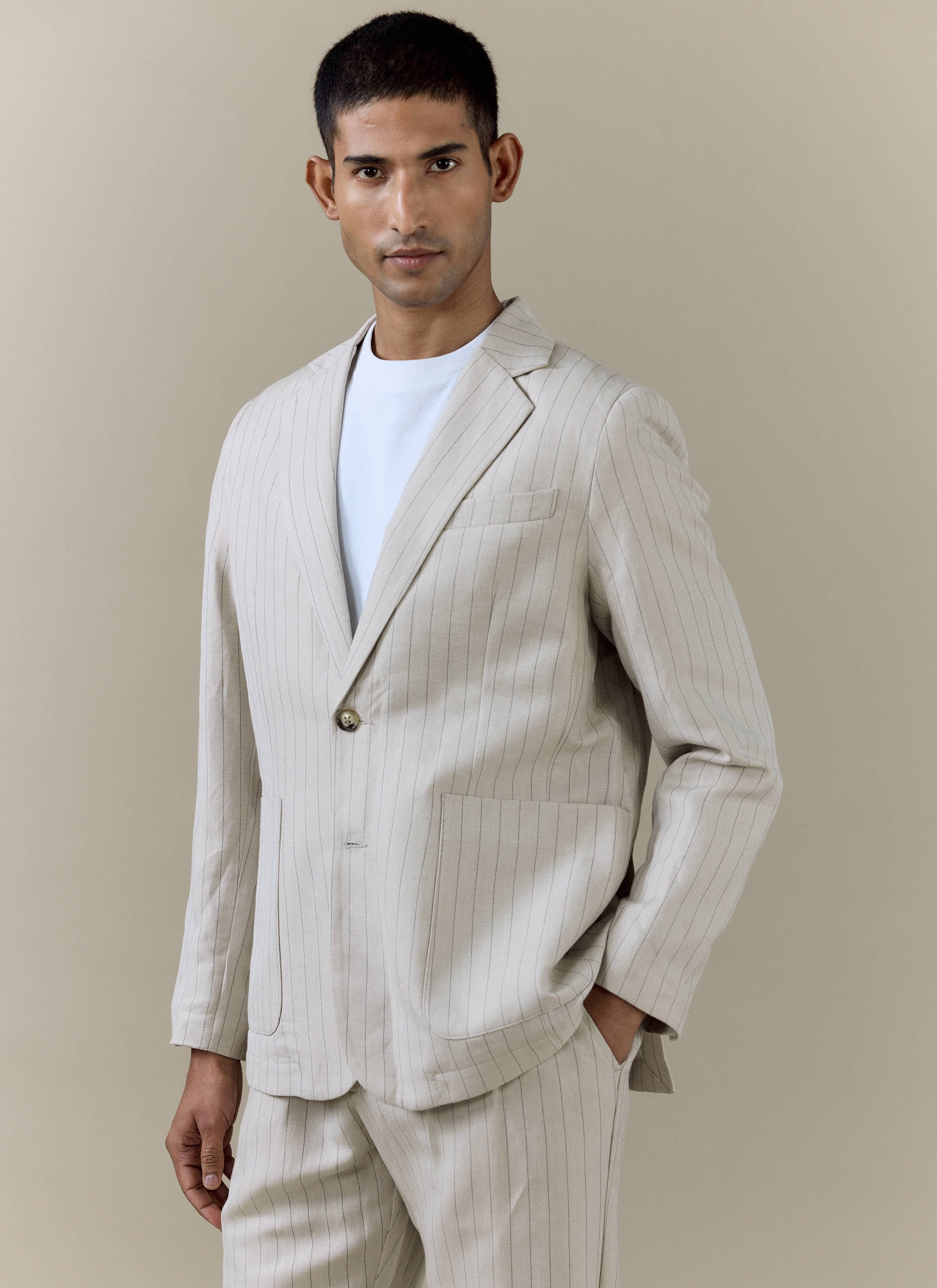 Percival Striped Tailored Blazer in cream pinstripe linen blend, styled with matching trousers and a white t-shirt.