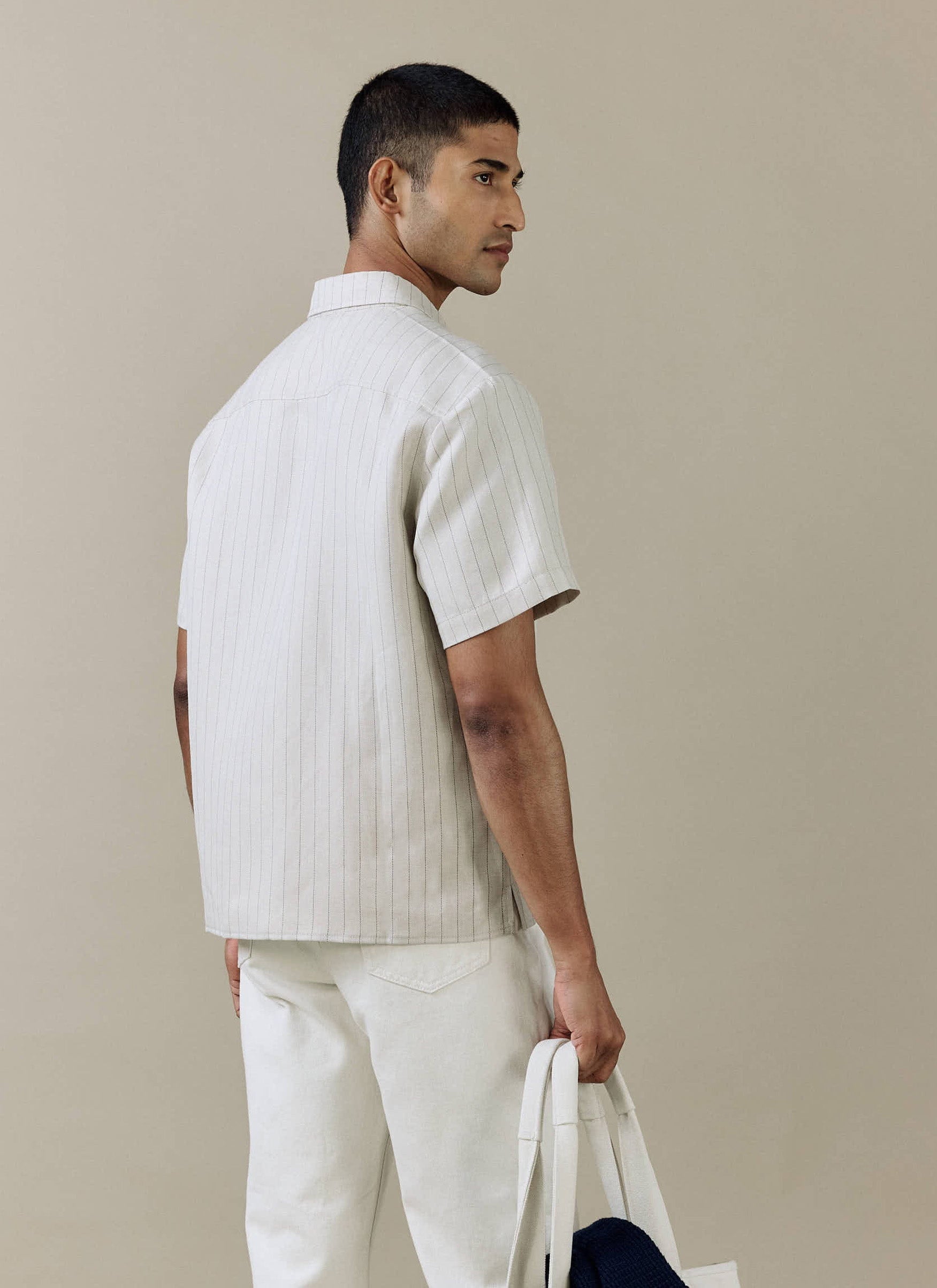 Rear view of the Percival Striped Boxy Shirt in cream linen blend, showing the pinstripe detail on a model.