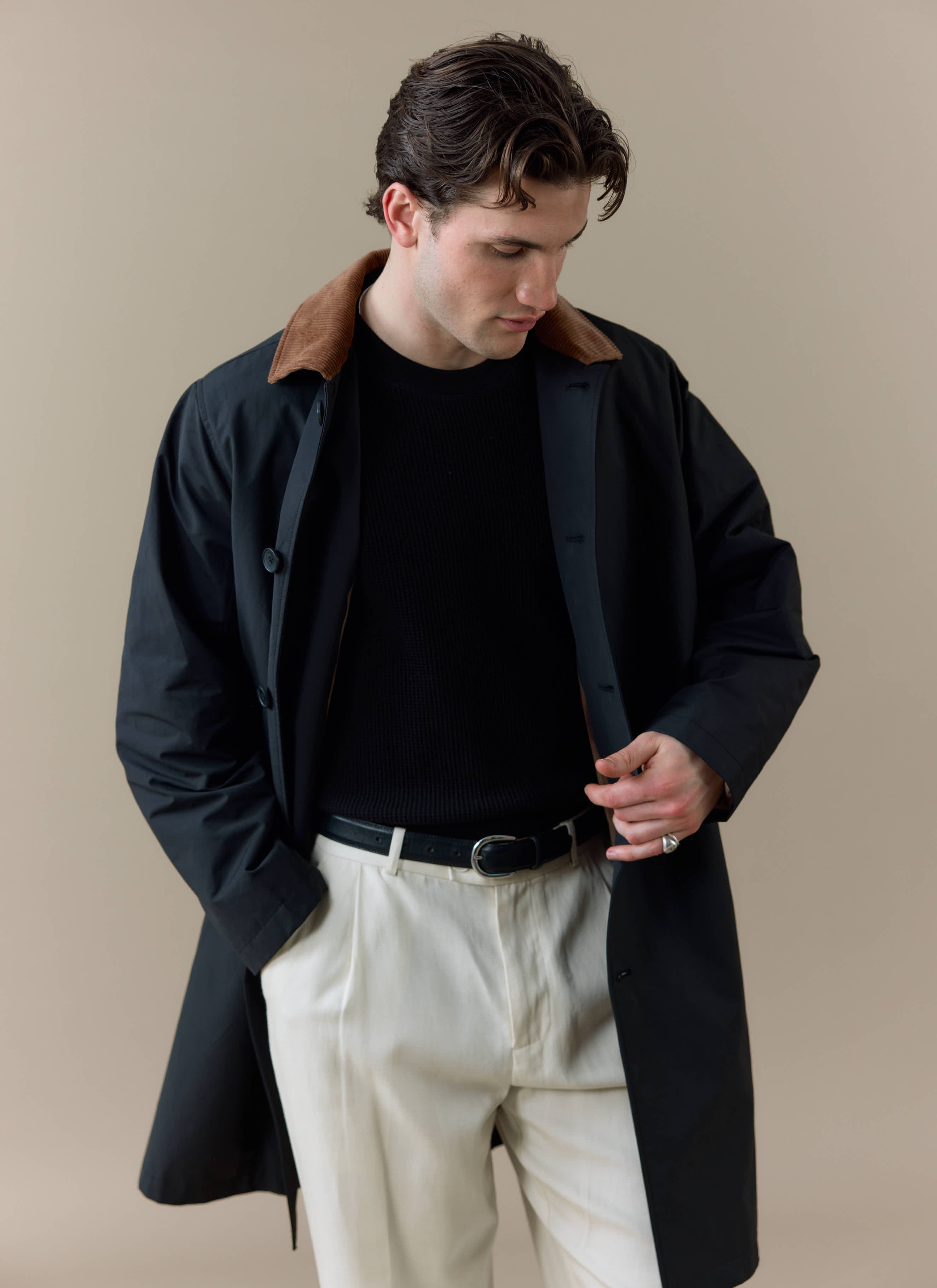 Model wears the black Percival Cord Collar Relaxed Trench Coat, featuring a contrast brown corduroy collar.