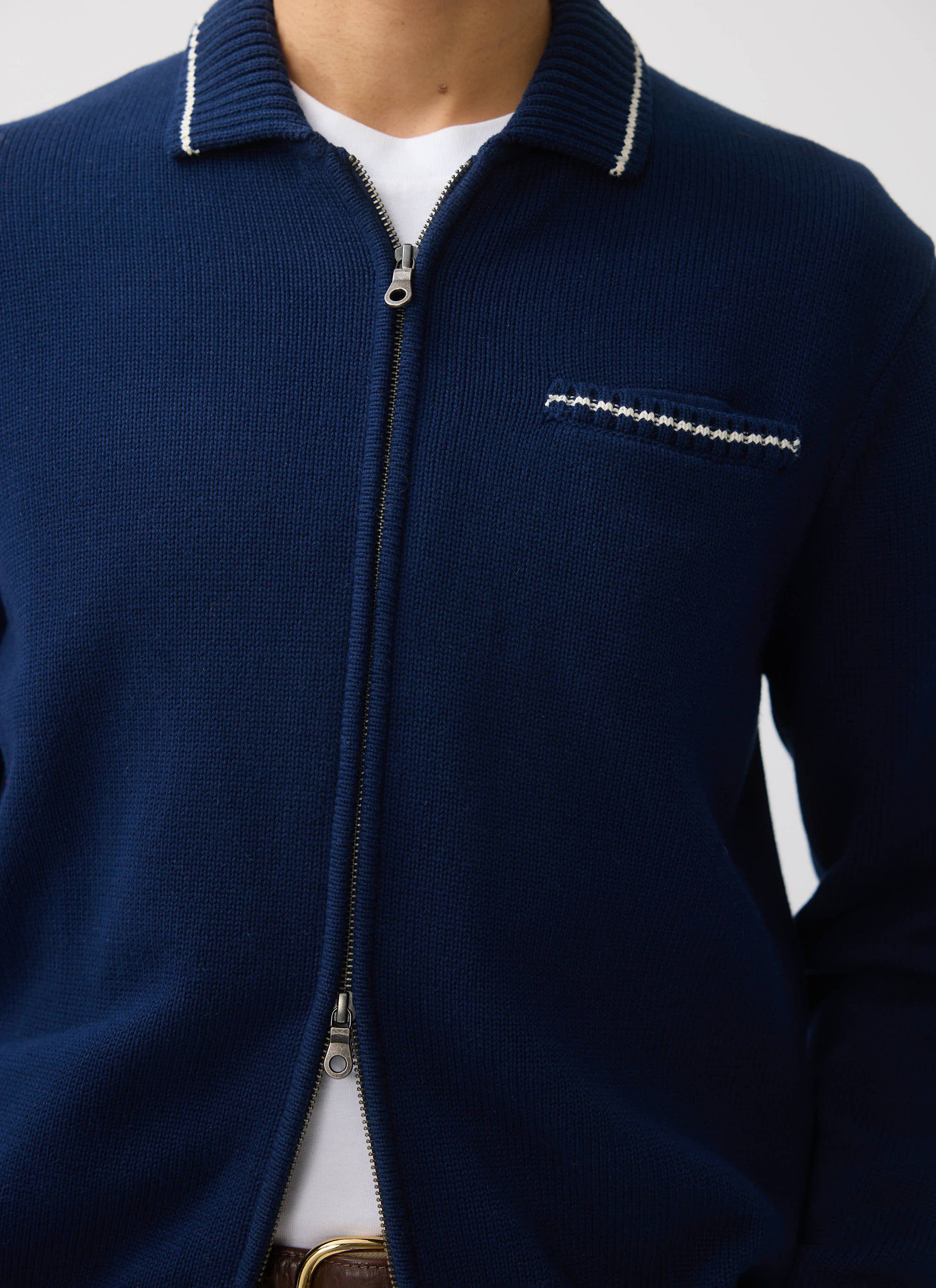 Close-up of the Percival Gardner navy knitted zip cardigan, showing the contrast stitch detail on the collar and pocket.