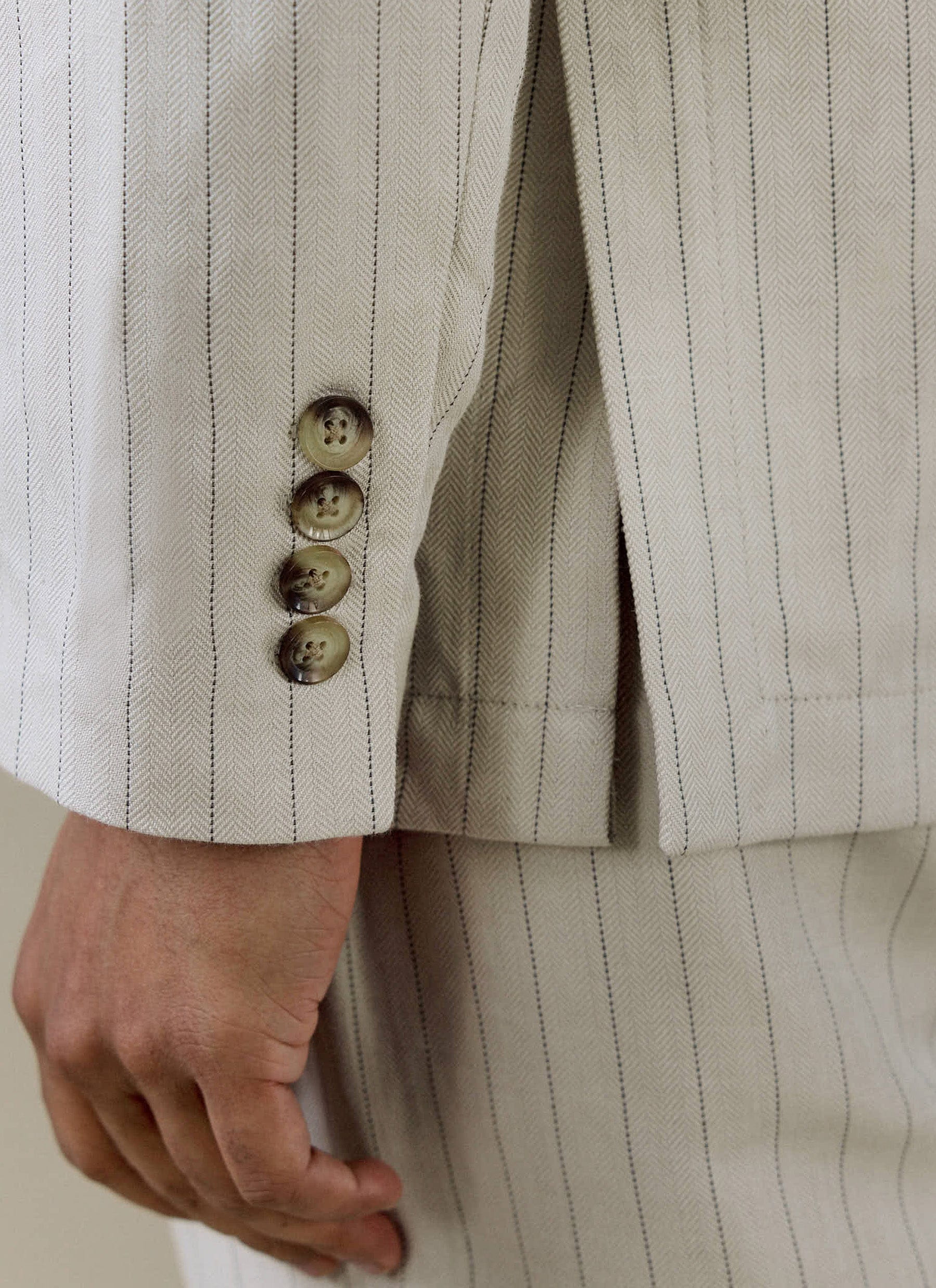Cream Percival Striped Tailored Blazer close-up, showing the pinstripe linen fabric and horn-effect sleeve buttons.
