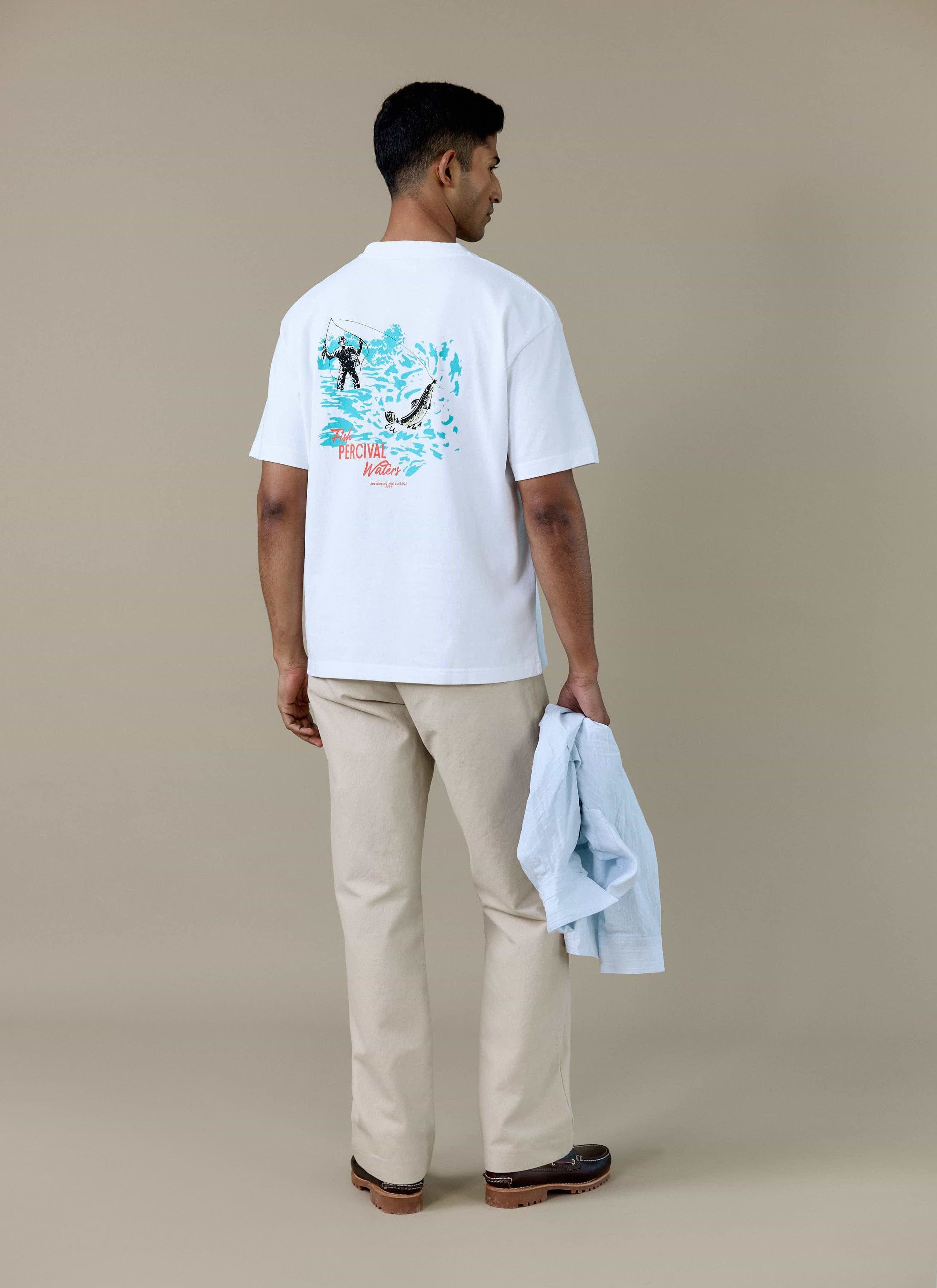 Rear view of a model in the white Percival Perci Waters Oversized T-shirt, showing the fisherman graphic on the back.