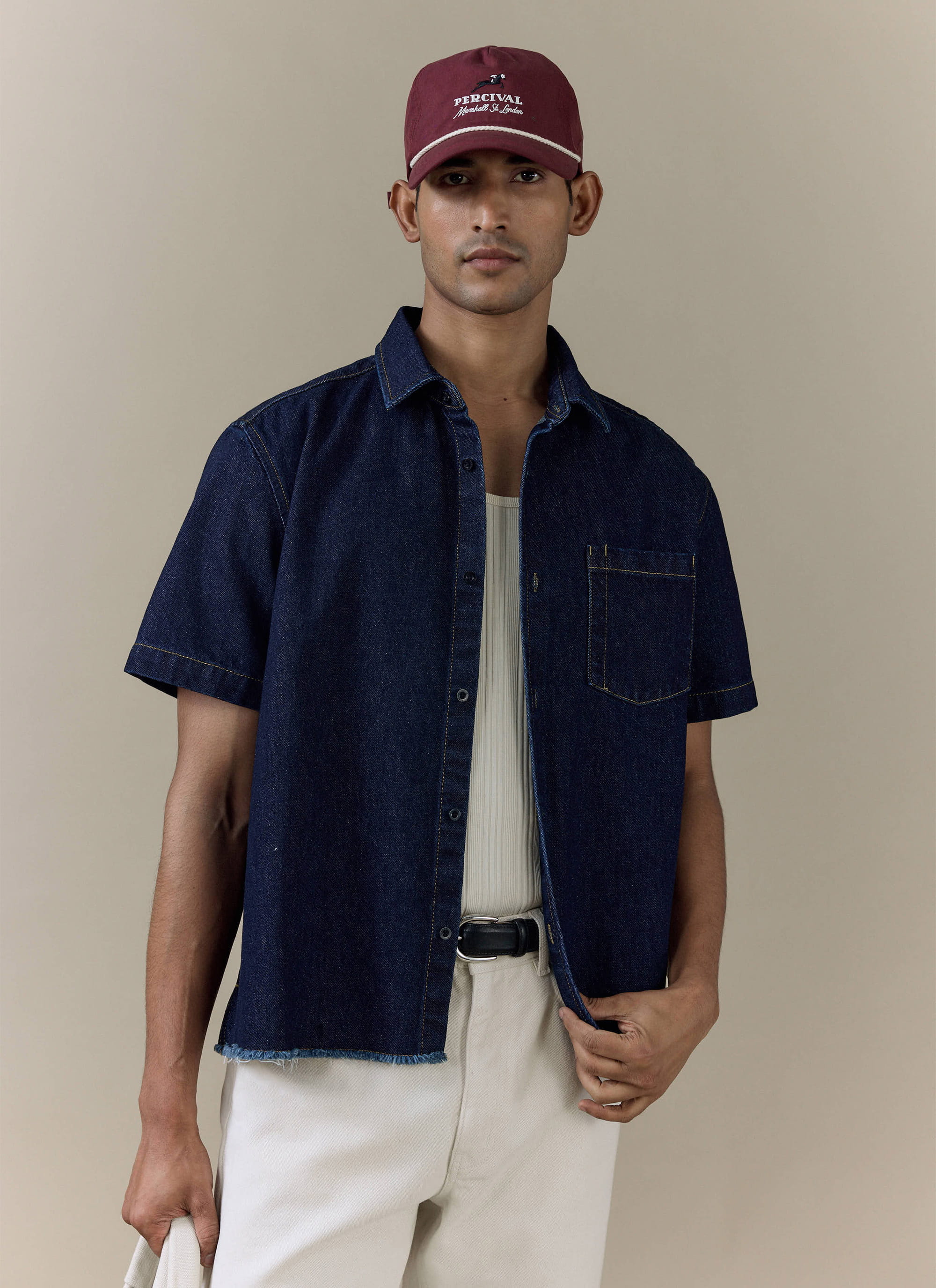 Percival Harley Denim Cropped Boxy Shirt in dark indigo cotton, featuring short sleeves and a frayed raw hem.