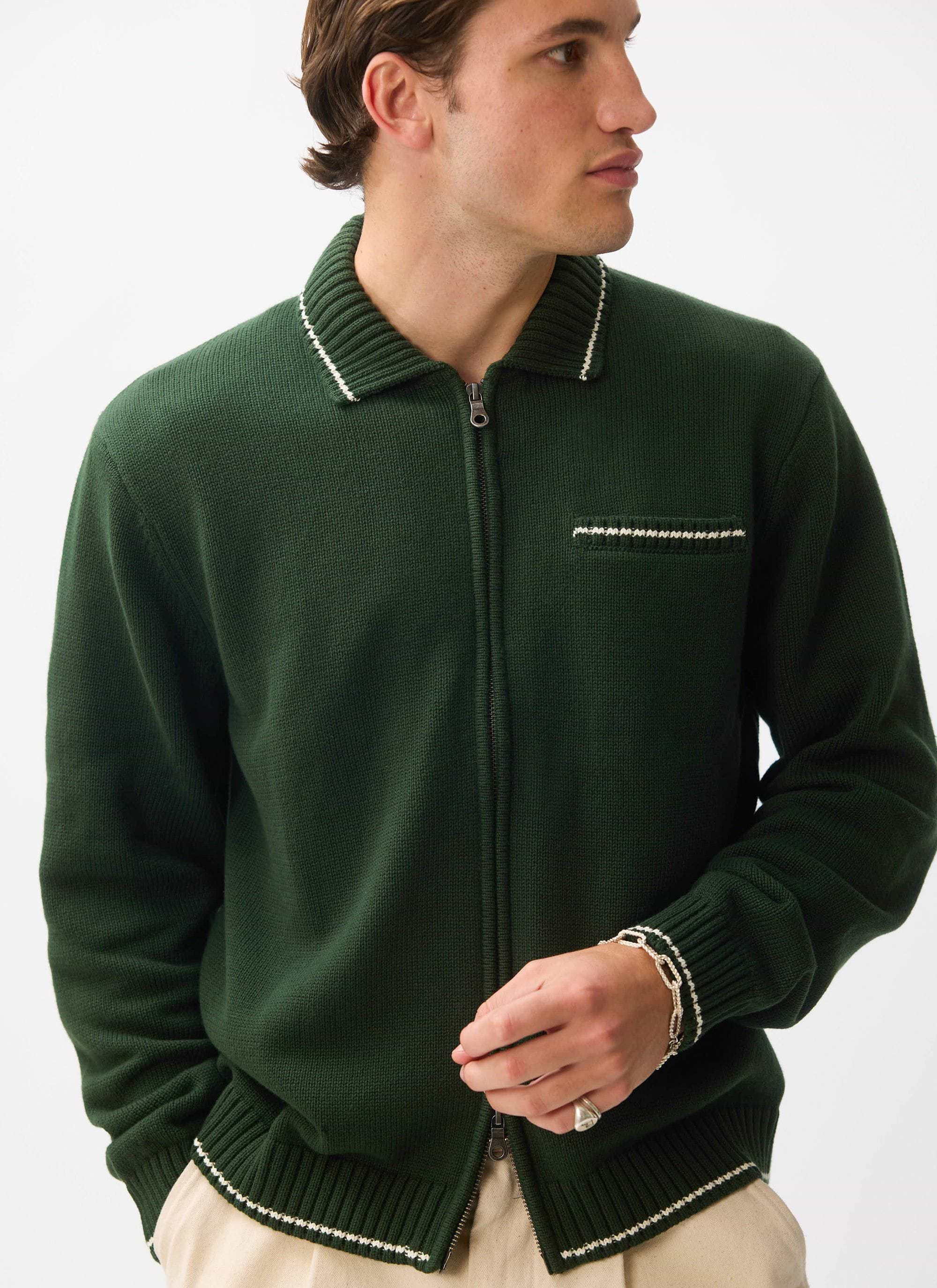 A model wears the Percival Gardner Knitted Zip Cardigan in forest green with contrast stitching on a white background.