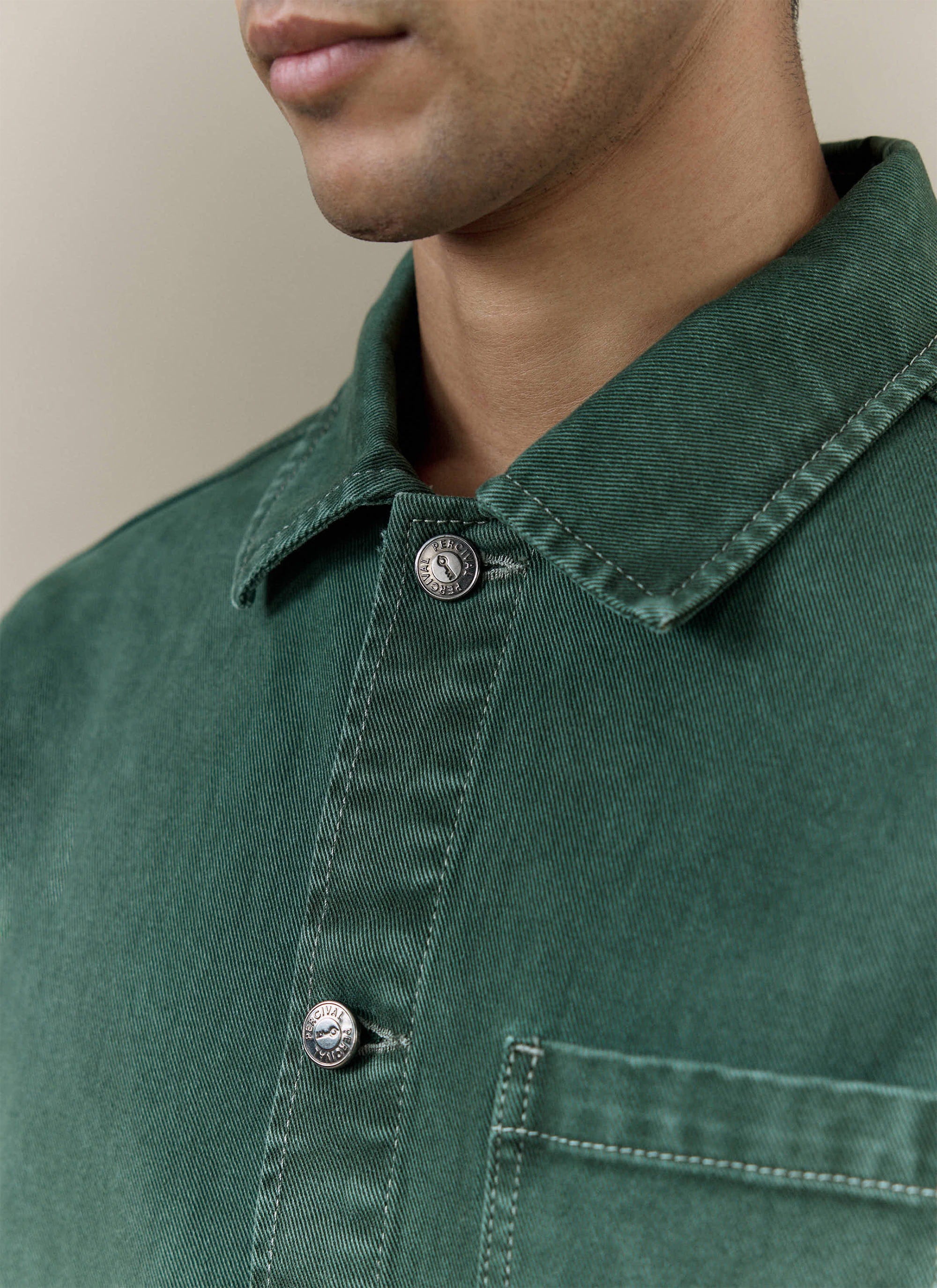 Close-up of the forest green Percival Vintage Wash Oliver Chore Jacket in cotton canvas, showing the branded metal buttons.