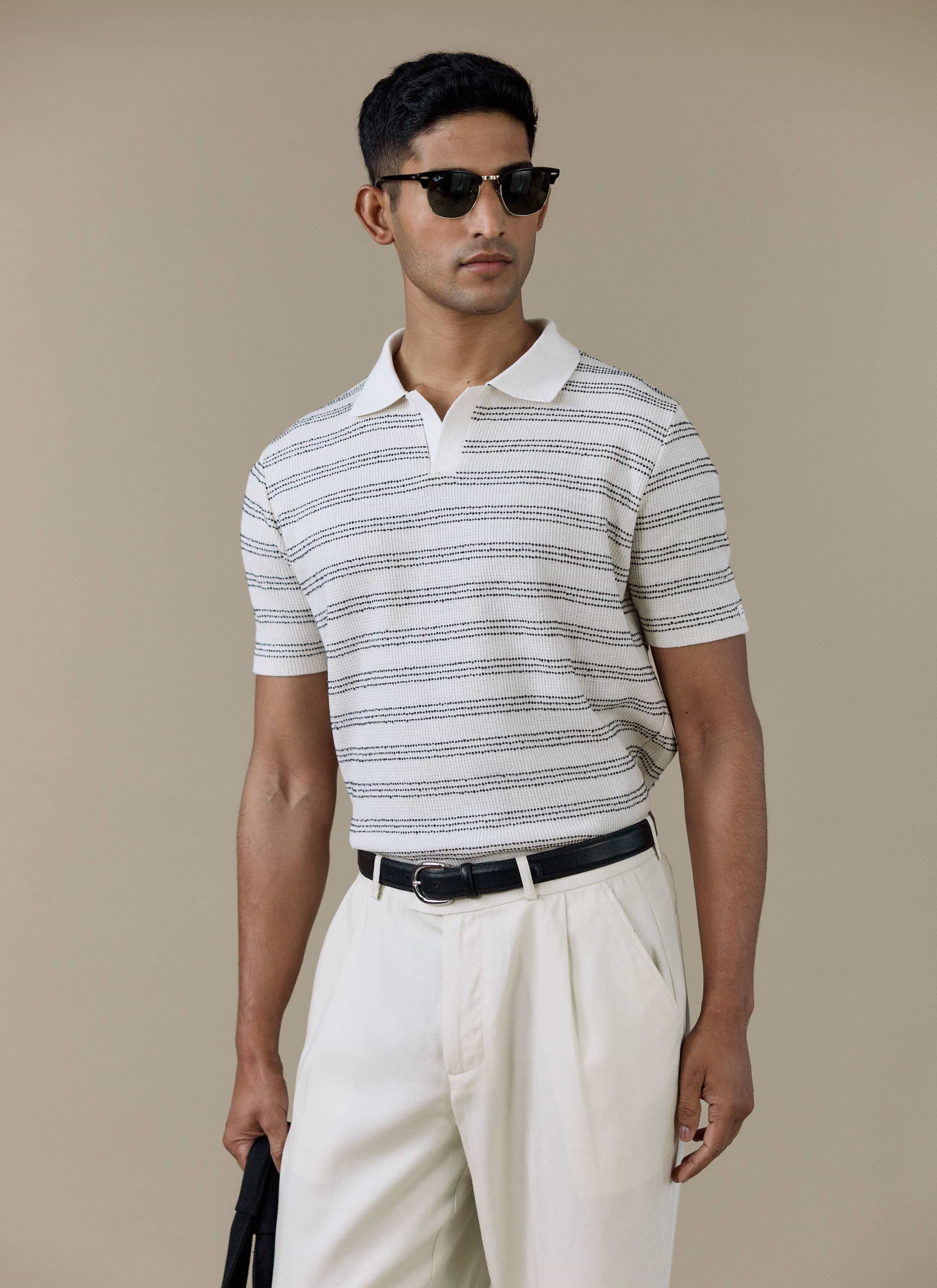 Model wearing the Percival Laurent Boxy Polo in cream, featuring horizontal stripes and an open collar.