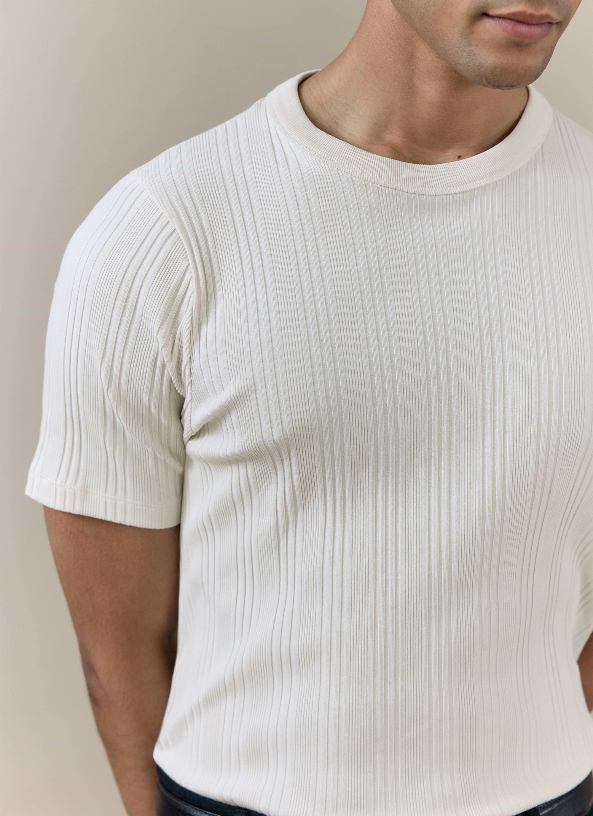 Close-up of the Percival Leon Ribbed T Shirt in cream organic cotton, highlighting the detailed vertical texture.