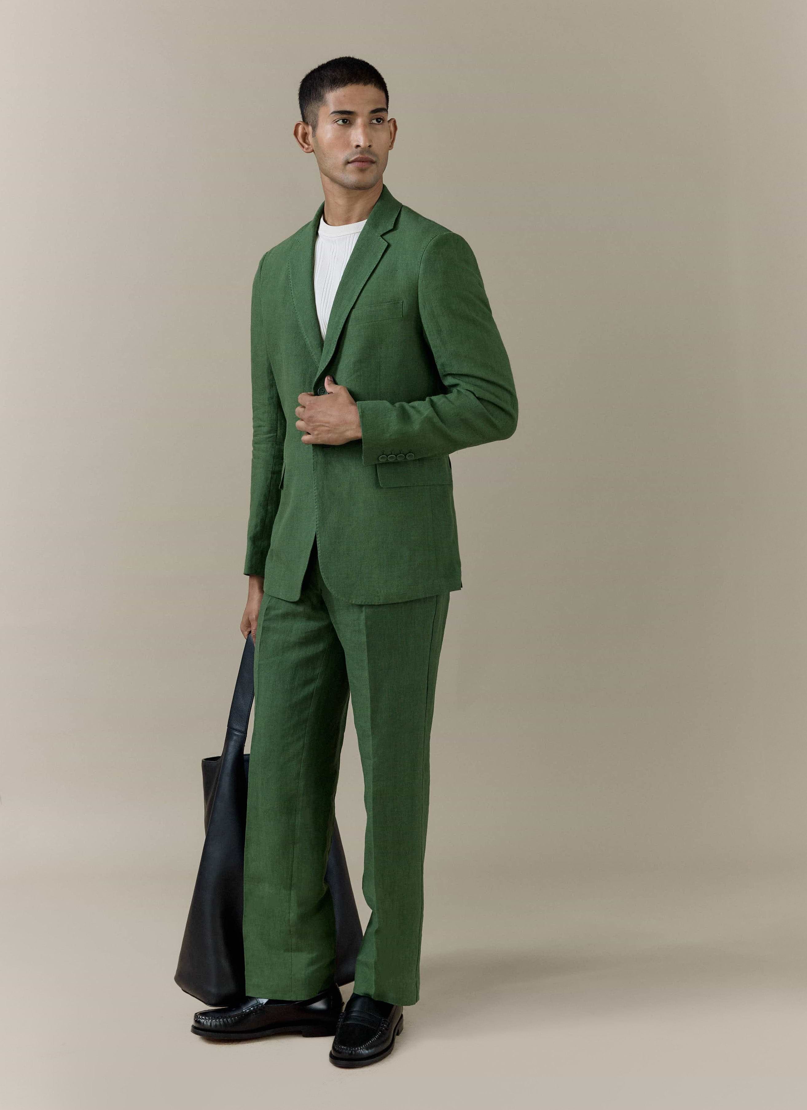 Forest green Percival slim fit classic blazer in 100% linen, styled with matching trousers and a black leather tote bag.