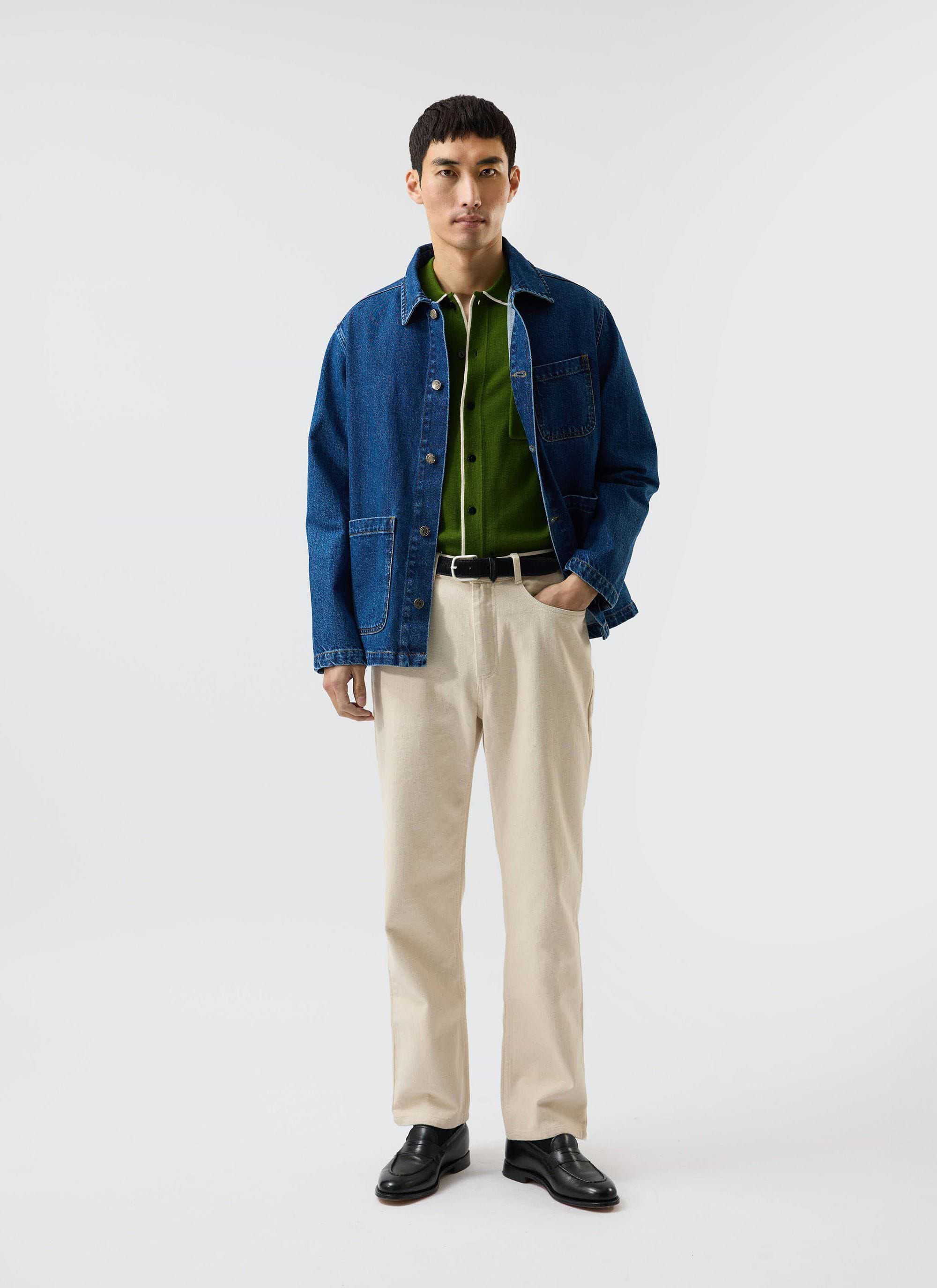 A model wears the Percival Contrast Trim Shirt in forest green under a denim jacket, with ecru trousers and loafers.