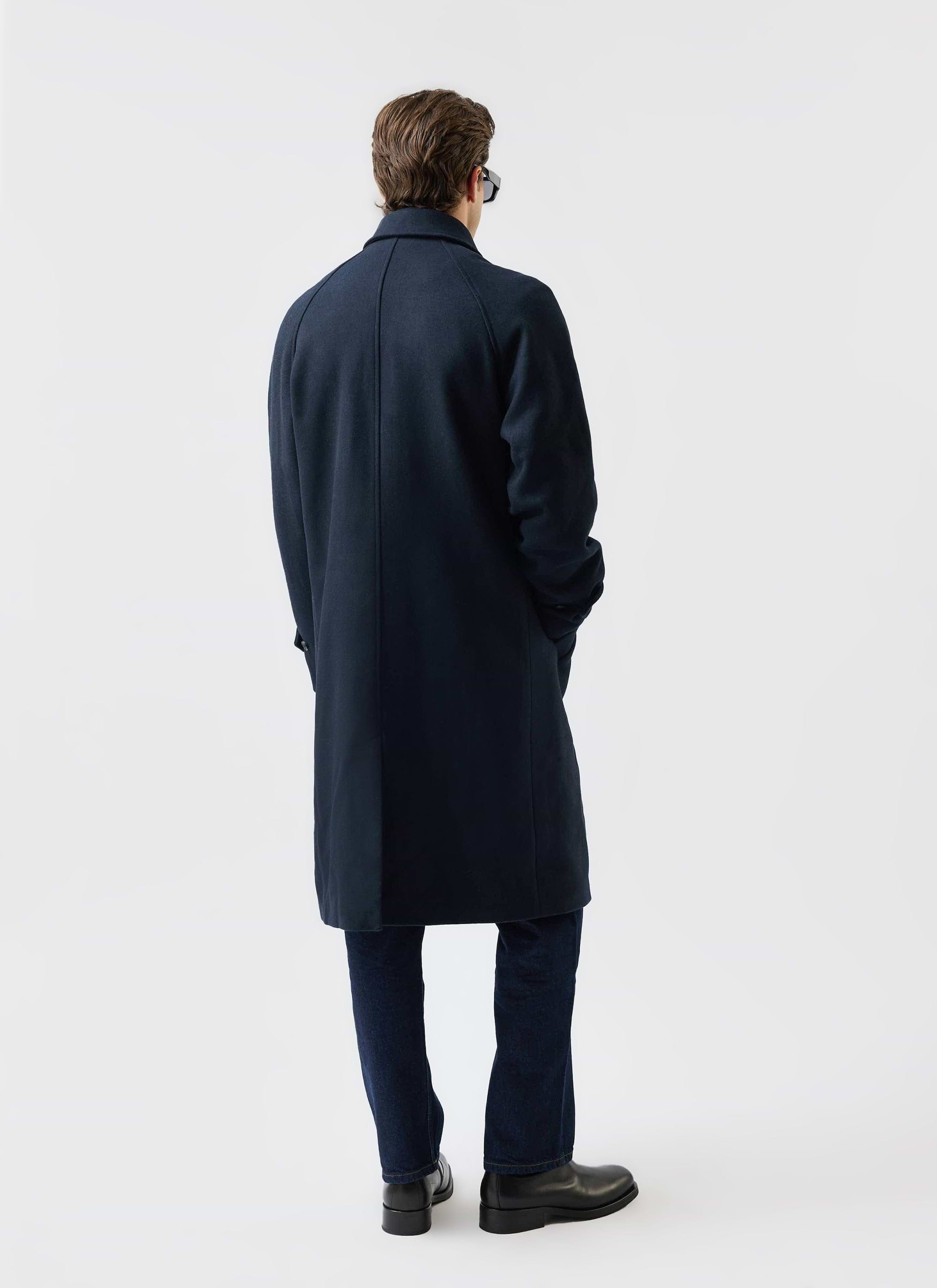 A model wears the Percival navy Wool Car Coat, shot from behind to showcase the garment's classic silhouette.