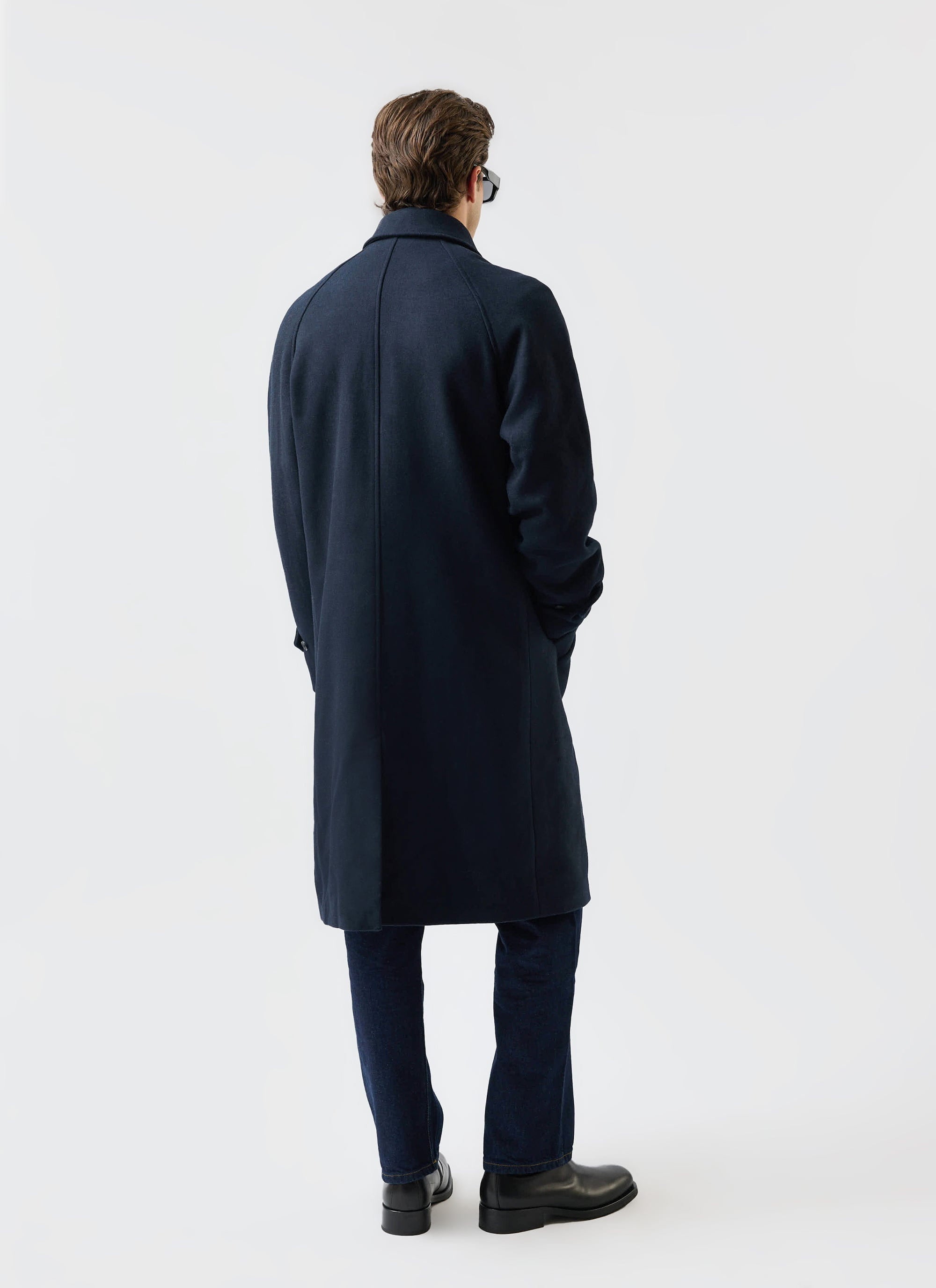 A model wears the Percival navy Wool Car Coat, shot from behind to showcase the garment's classic silhouette.