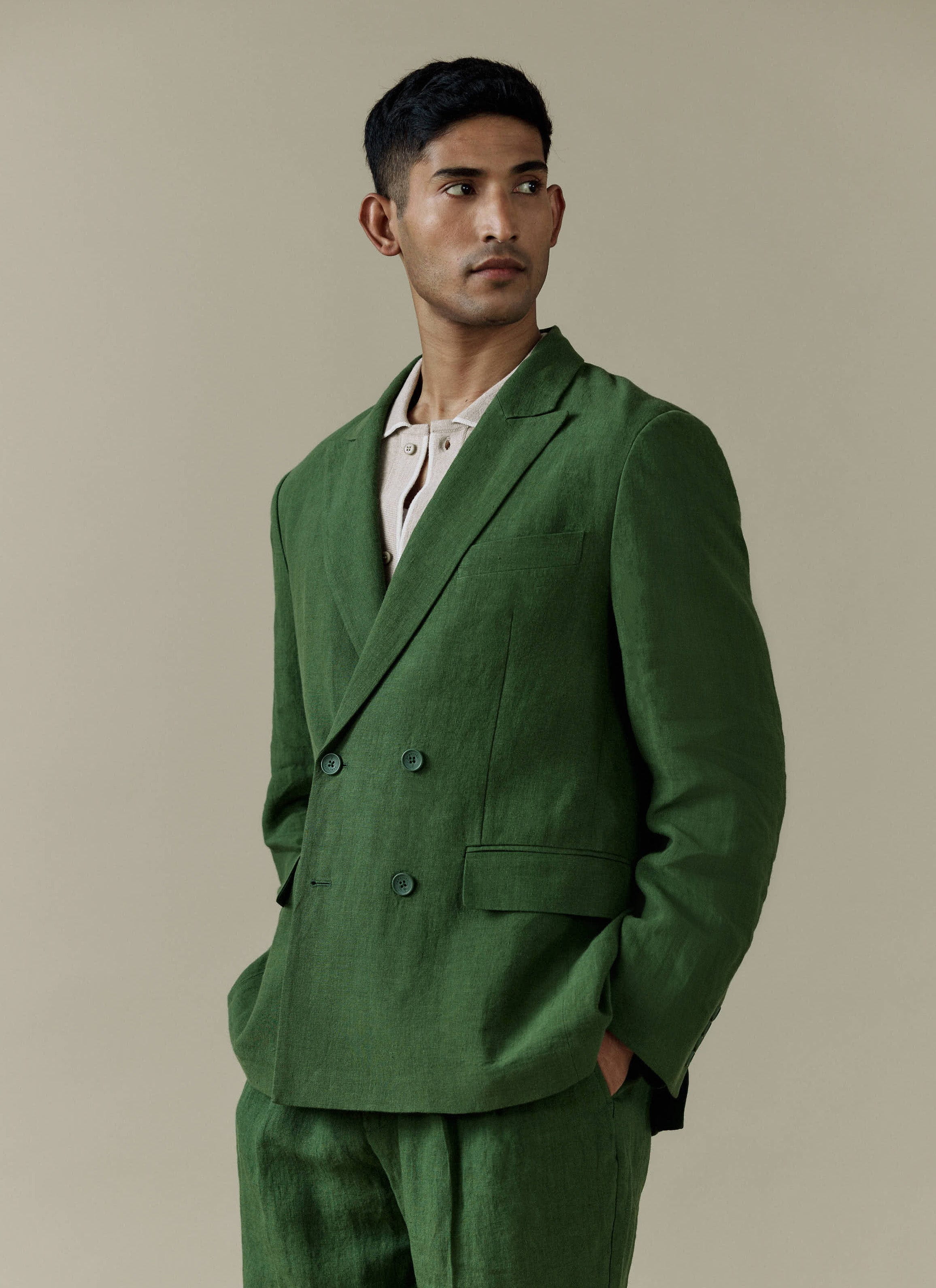 A model wears the Percival Clifton Double Breasted Blazer and matching trousers in forest green linen.