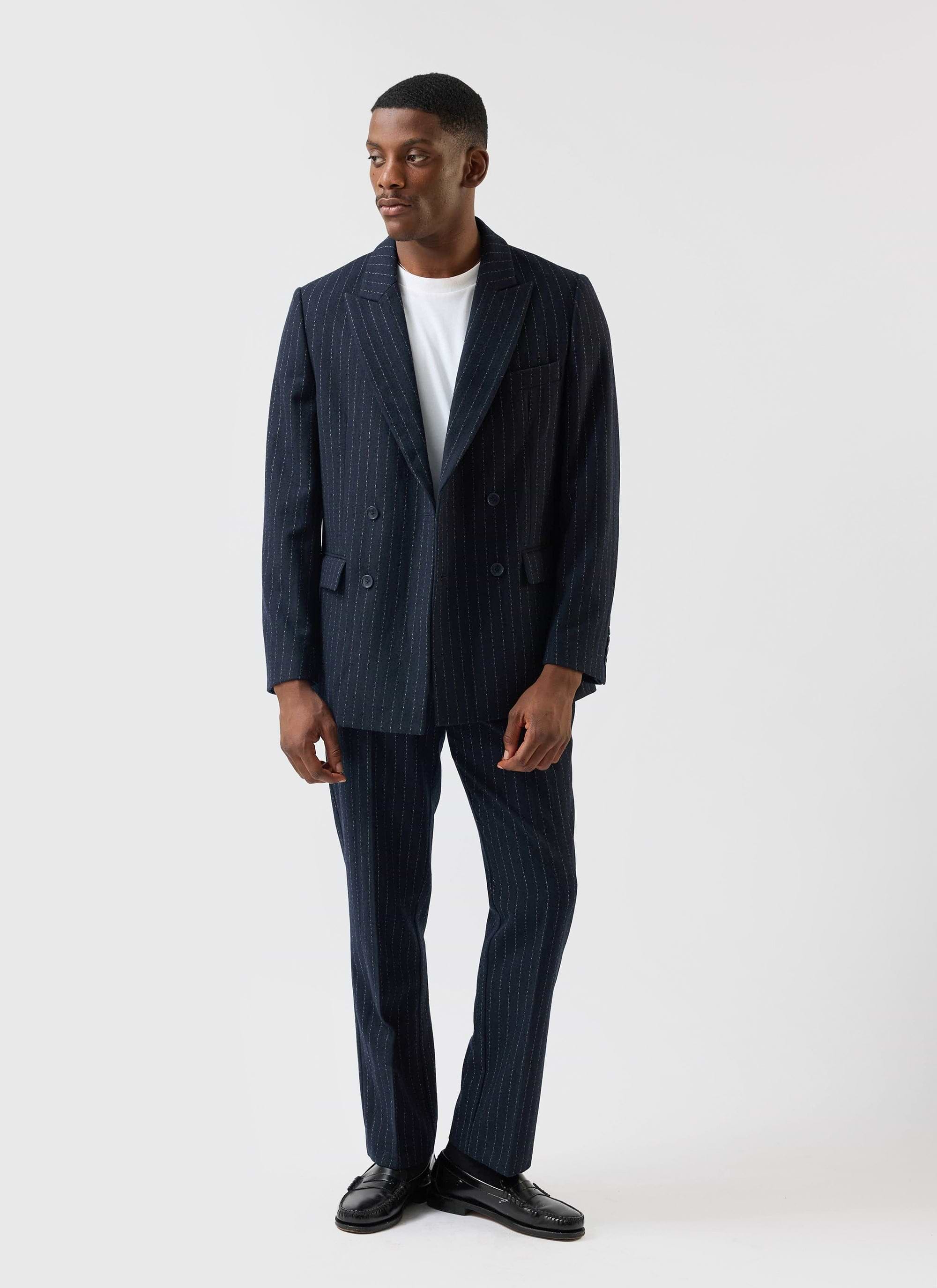 A model wears the Percival Textured Stripe Double Breasted Blazer in navy with matching trousers and a white t-shirt.
