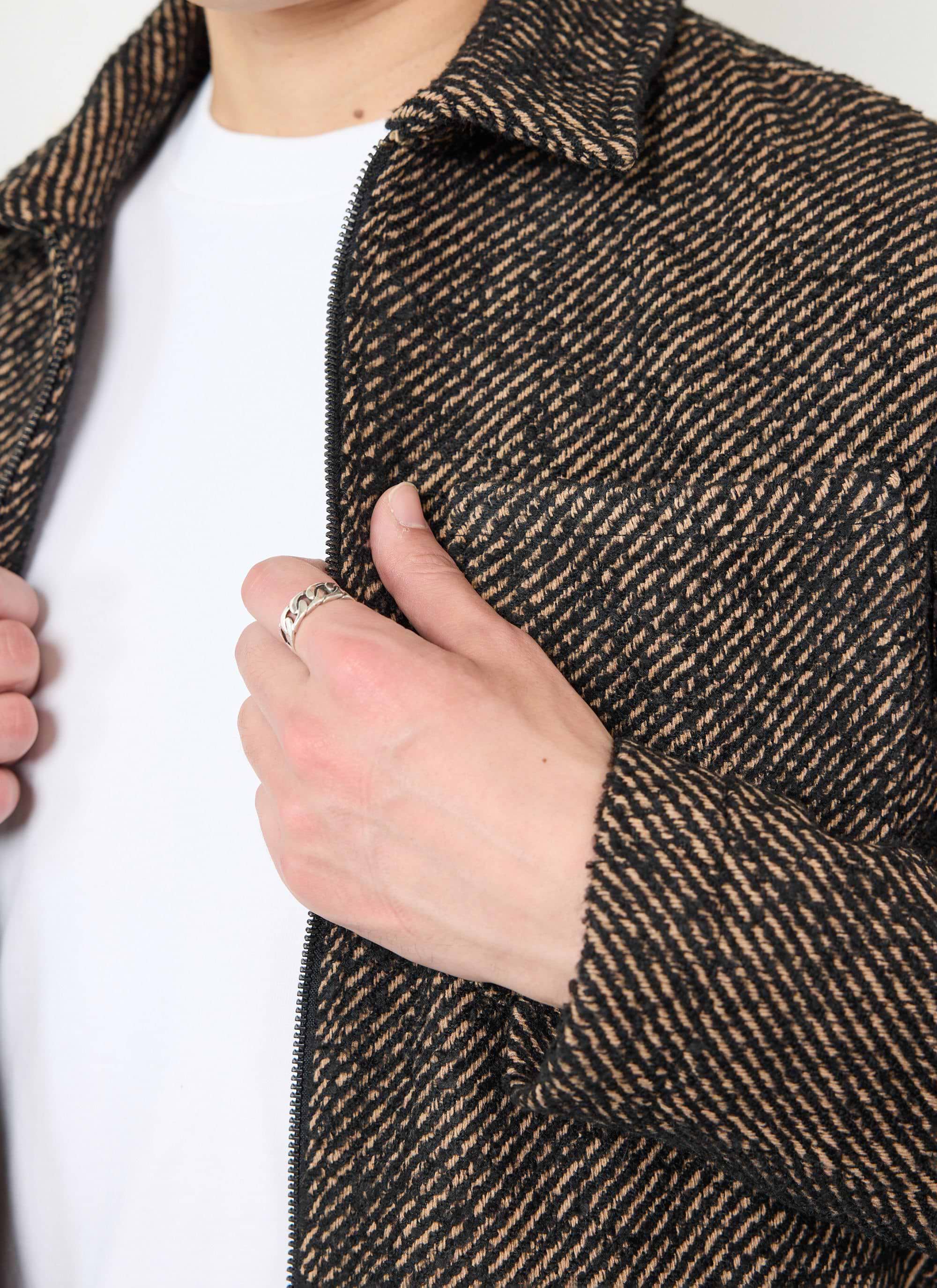 A close-up of the Percival Zip Overshirt in Oak Twill, showing the detailed fabric texture and zip fastening.