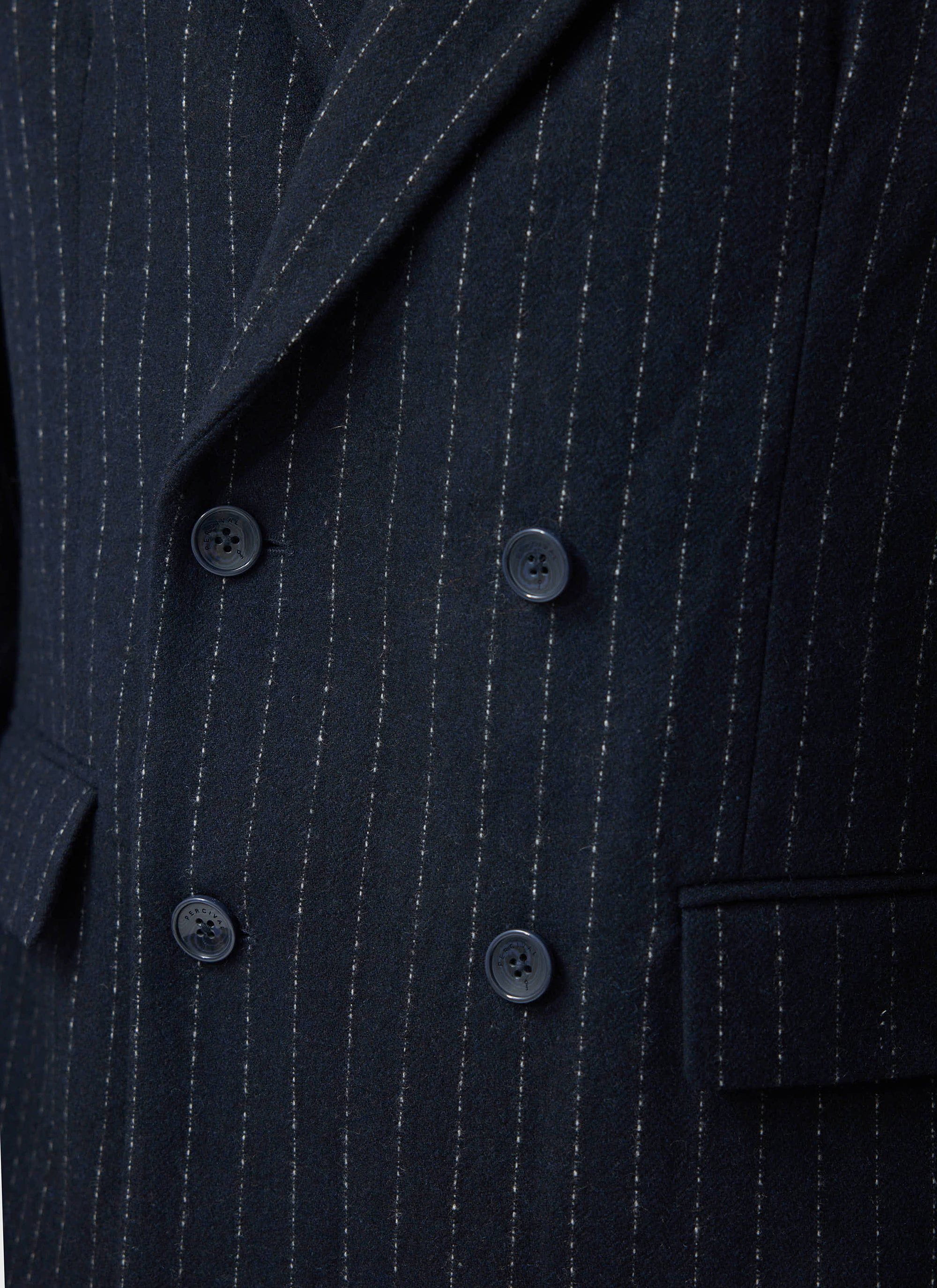 A close-up of the Percival Textured Stripe Double Breasted Blazer in navy, showing pinstripe wool-blend fabric and buttons.