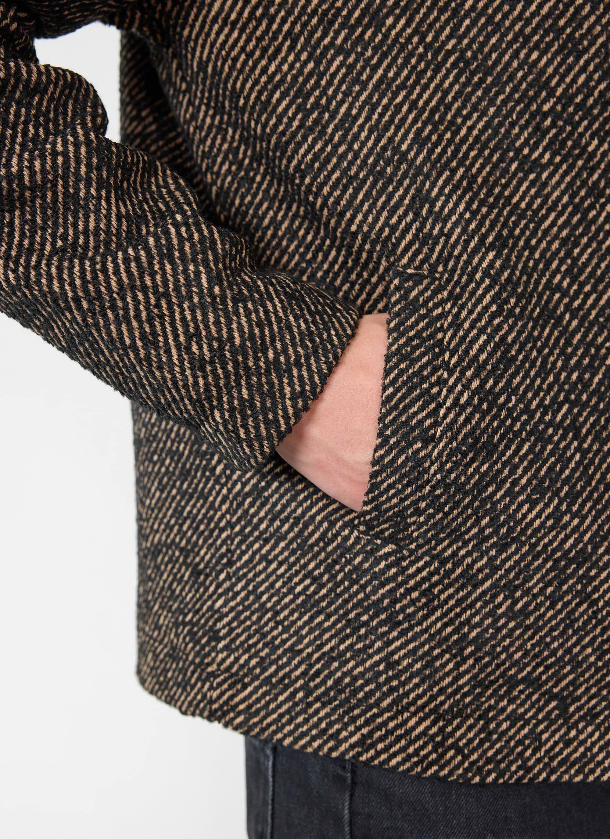 Close up of the percival Zip Overshirt in Oak twill, showing the textured fabric and side pocket detail.