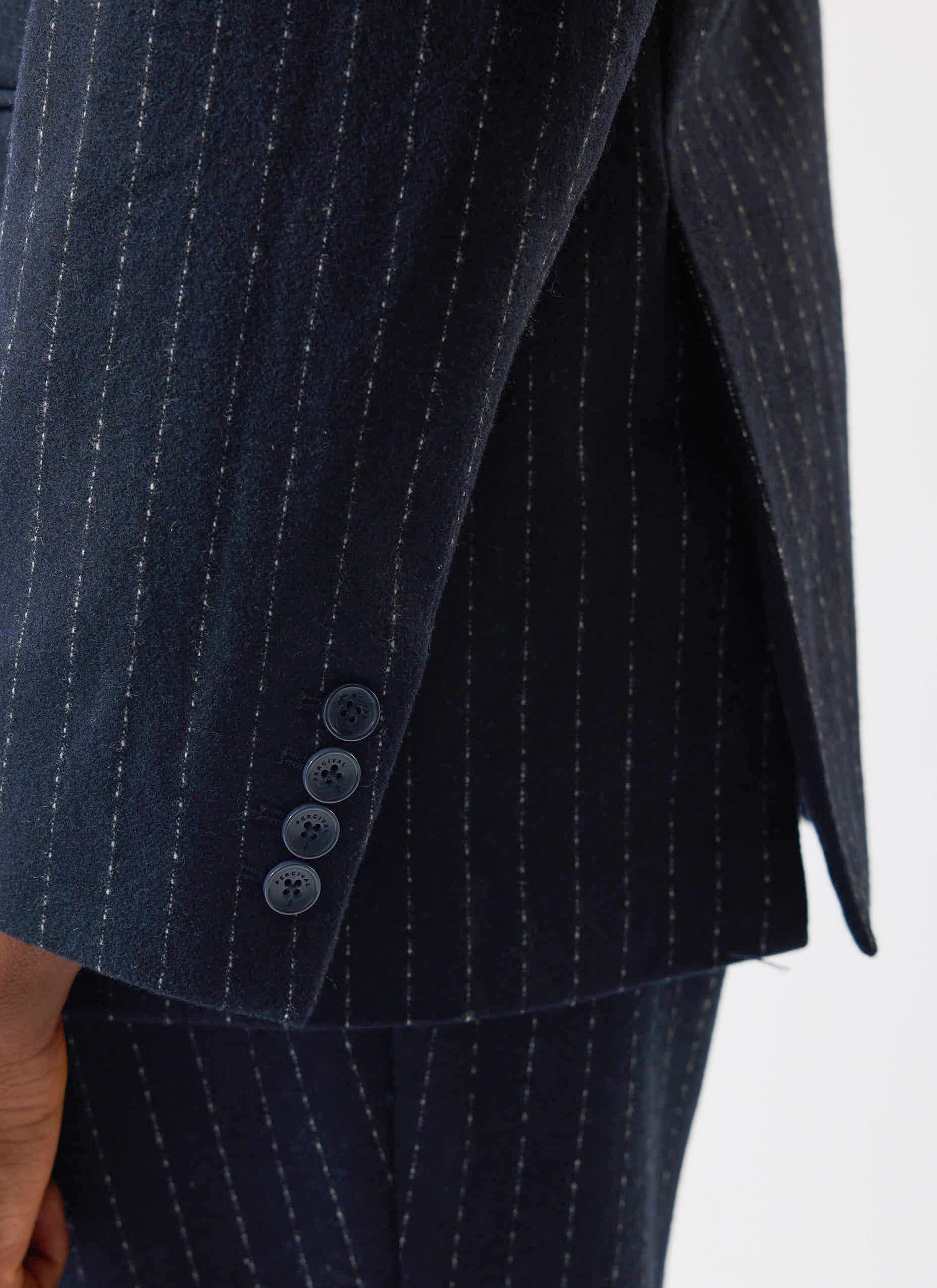 A detail shot of the Percival Textured Stripe Double Breasted Blazer in navy, with its branded cuff buttons and side vent.