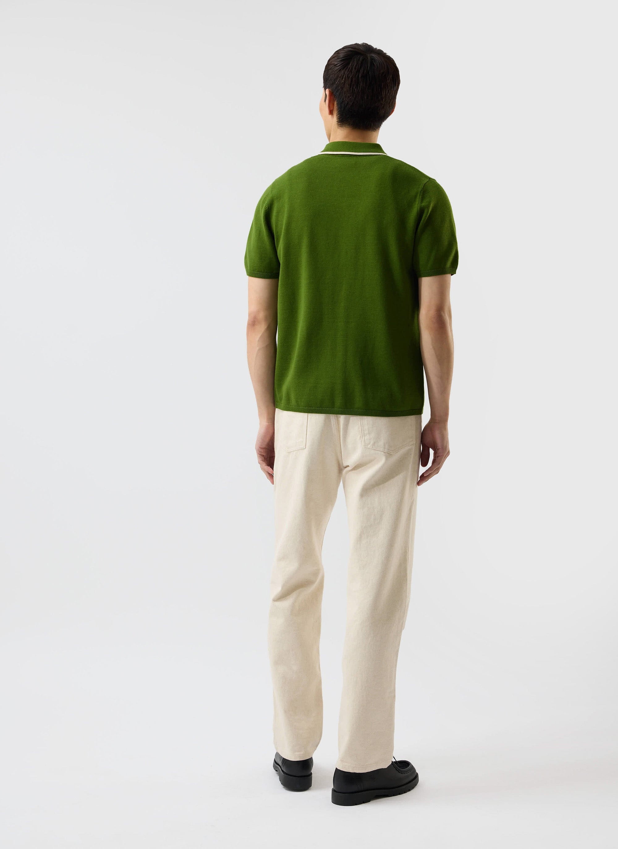 Back view of a model wearing the Percival Contrast Trim Shirt in forest green, a wool-blend knit with ecru collar detail.
