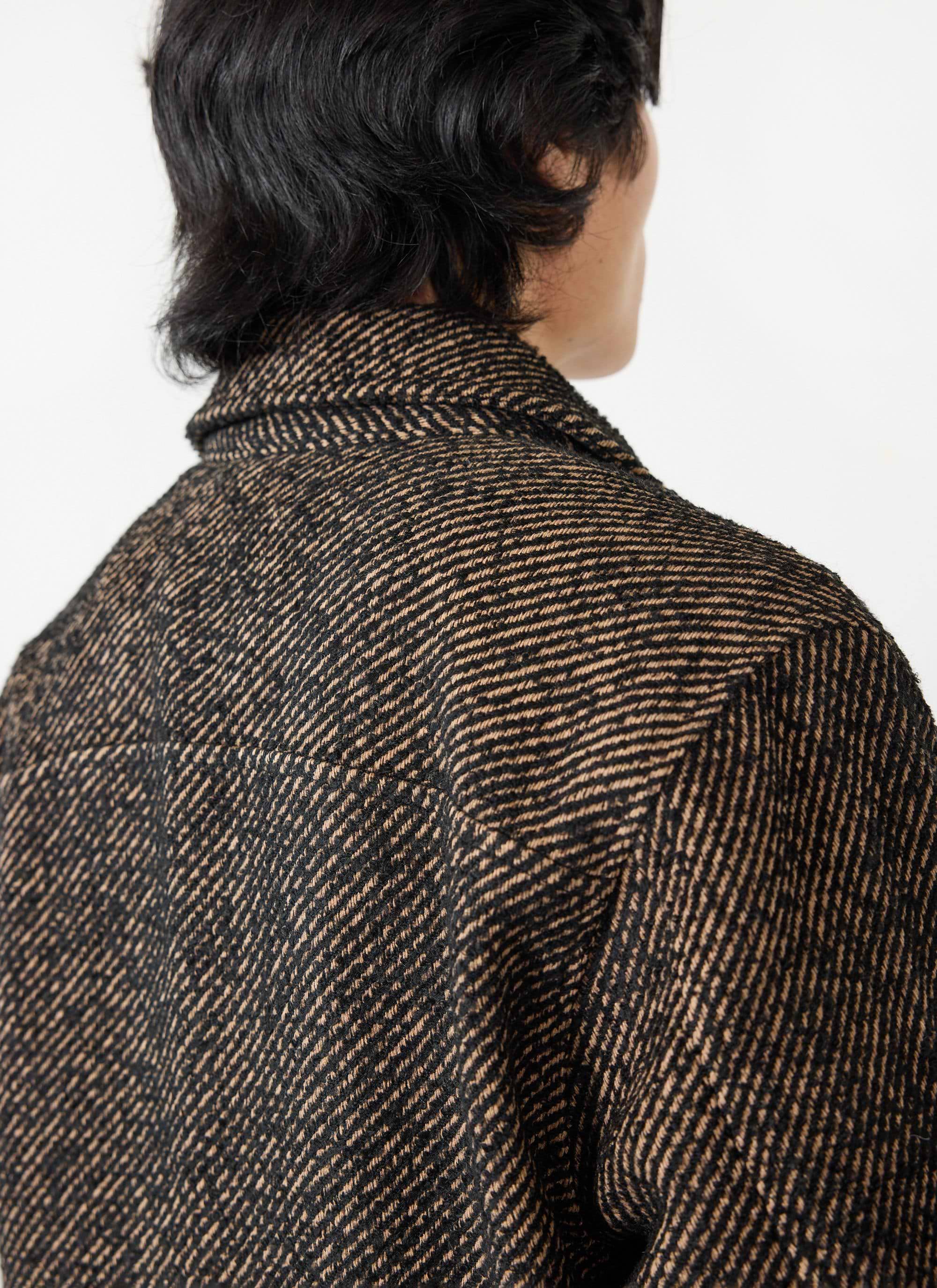close up of the black and oak twill fabric on the back of the percival zip overshirt