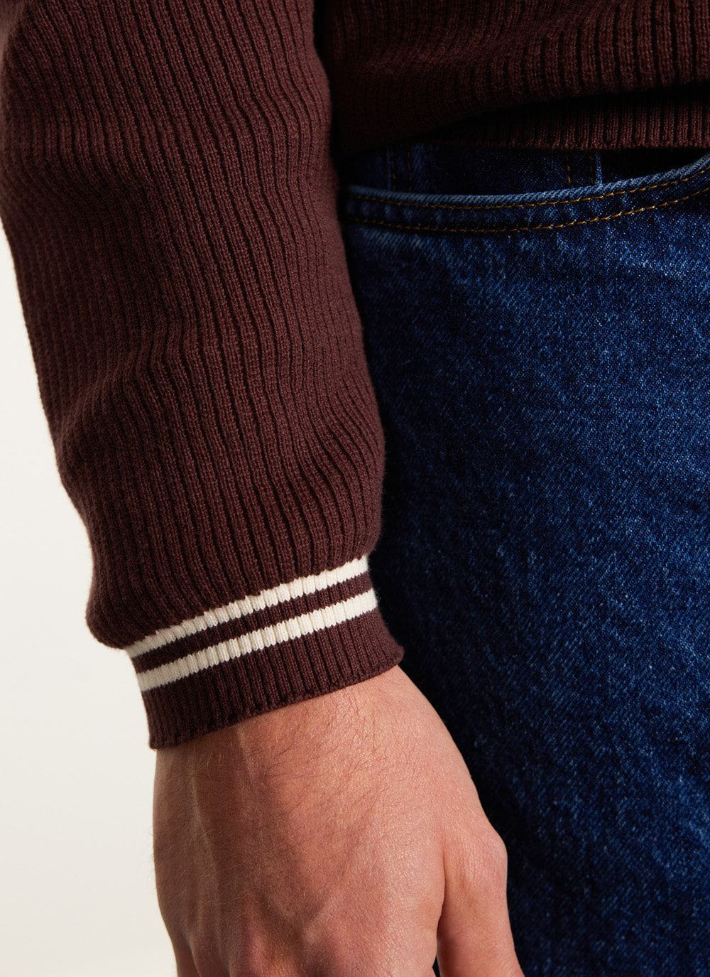 A close-up of the ribbed cuff on the Percival Pablo Knitted Shirt in espresso, featuring two white stripes.
