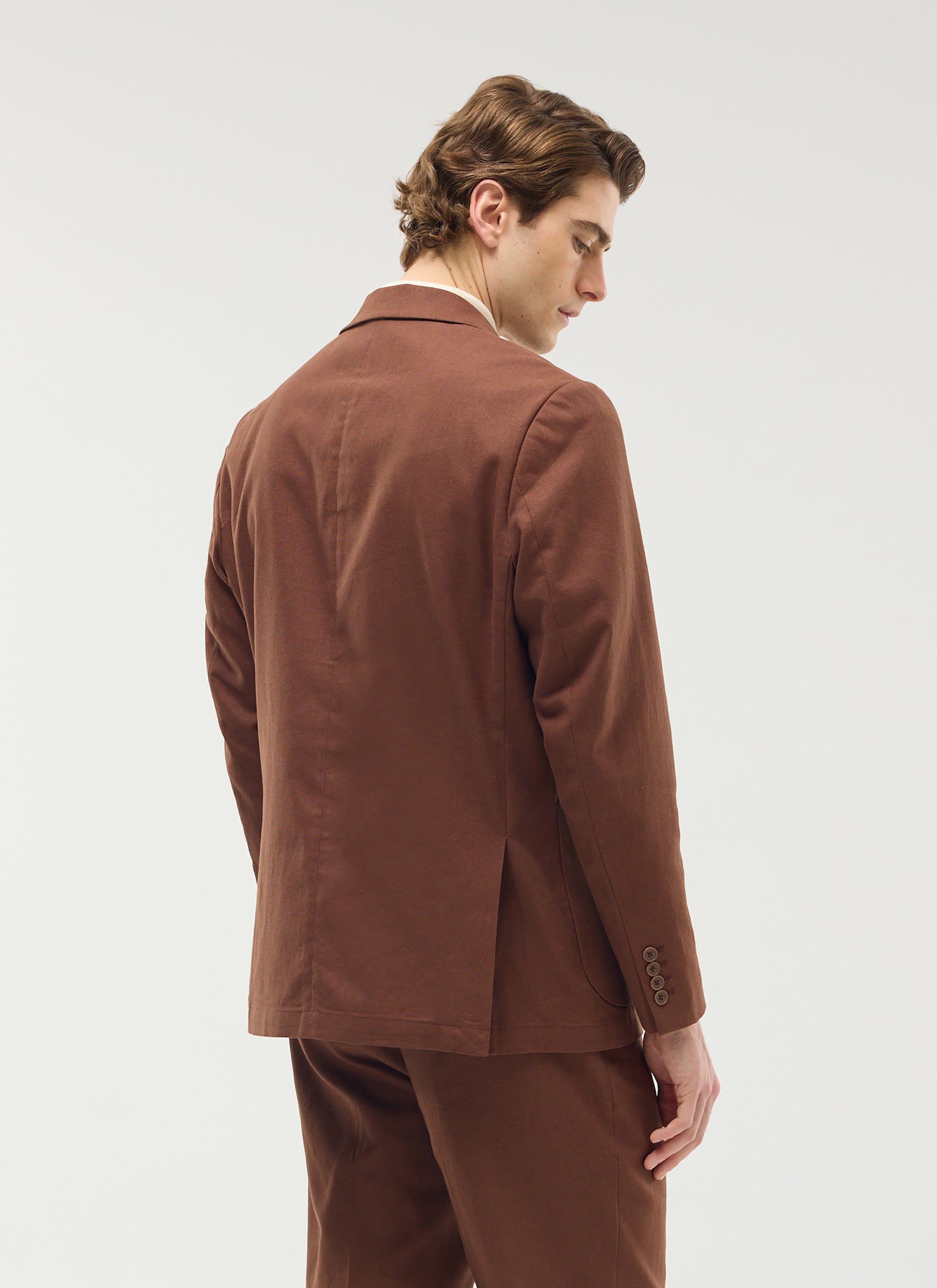 The Percival Tailored Linen Blazer in brown, shown from behind on a model to highlight its tailored fit.