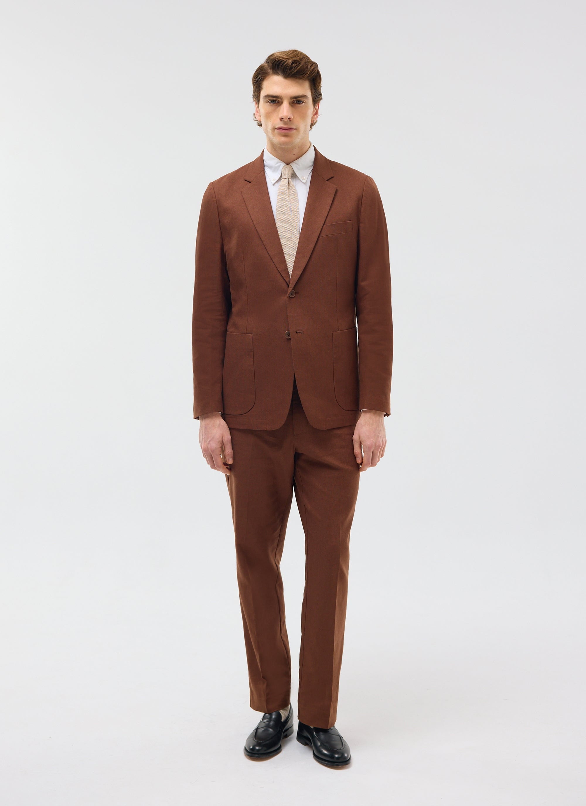 Percival Tailored Linen Blazer in brown, styled on a model as a full suit with matching trousers against a white background.