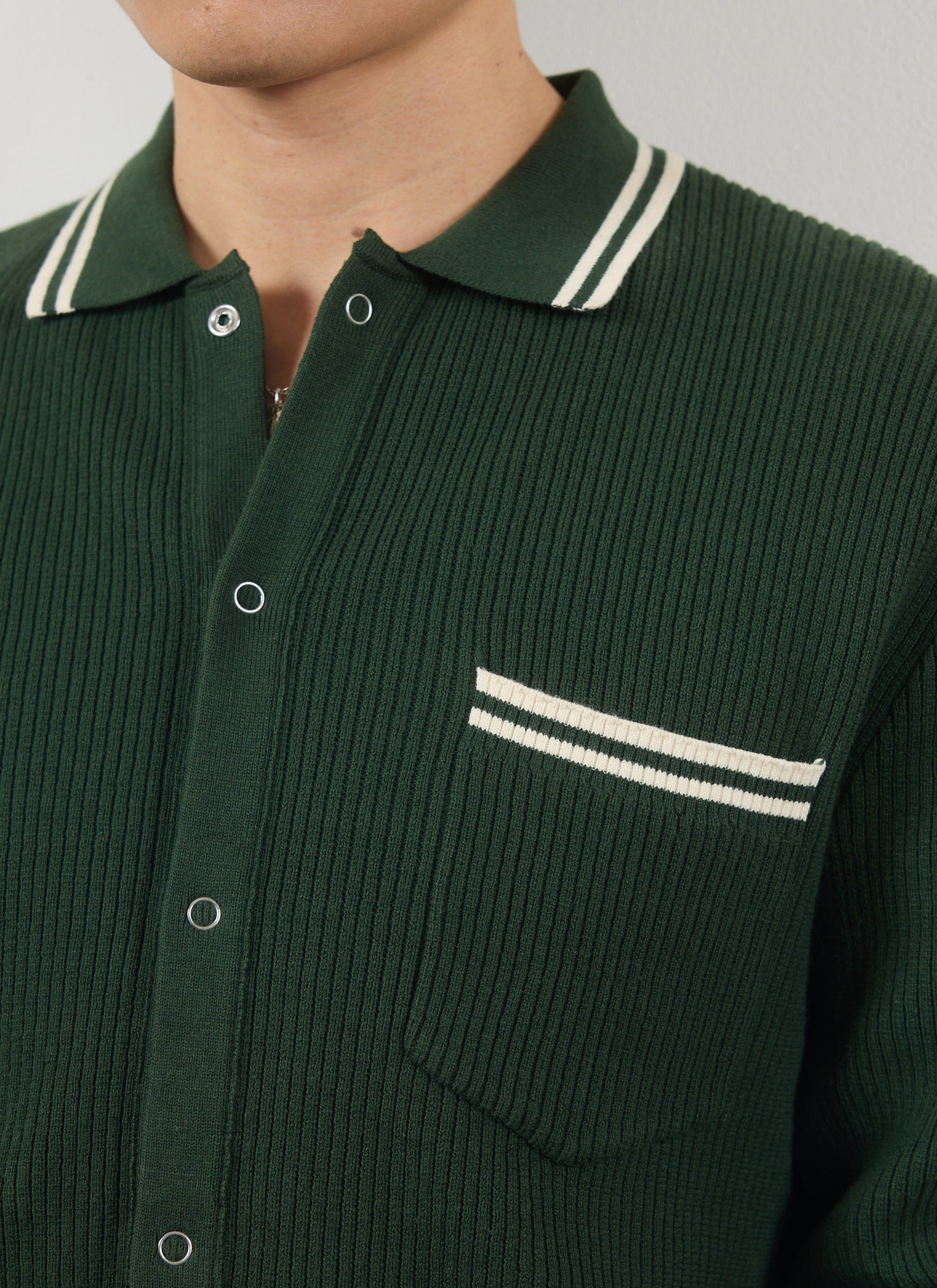 Close up of the Percival Pablo ribbed knitted shirt in forest green, showing the white striped collar and pocket.