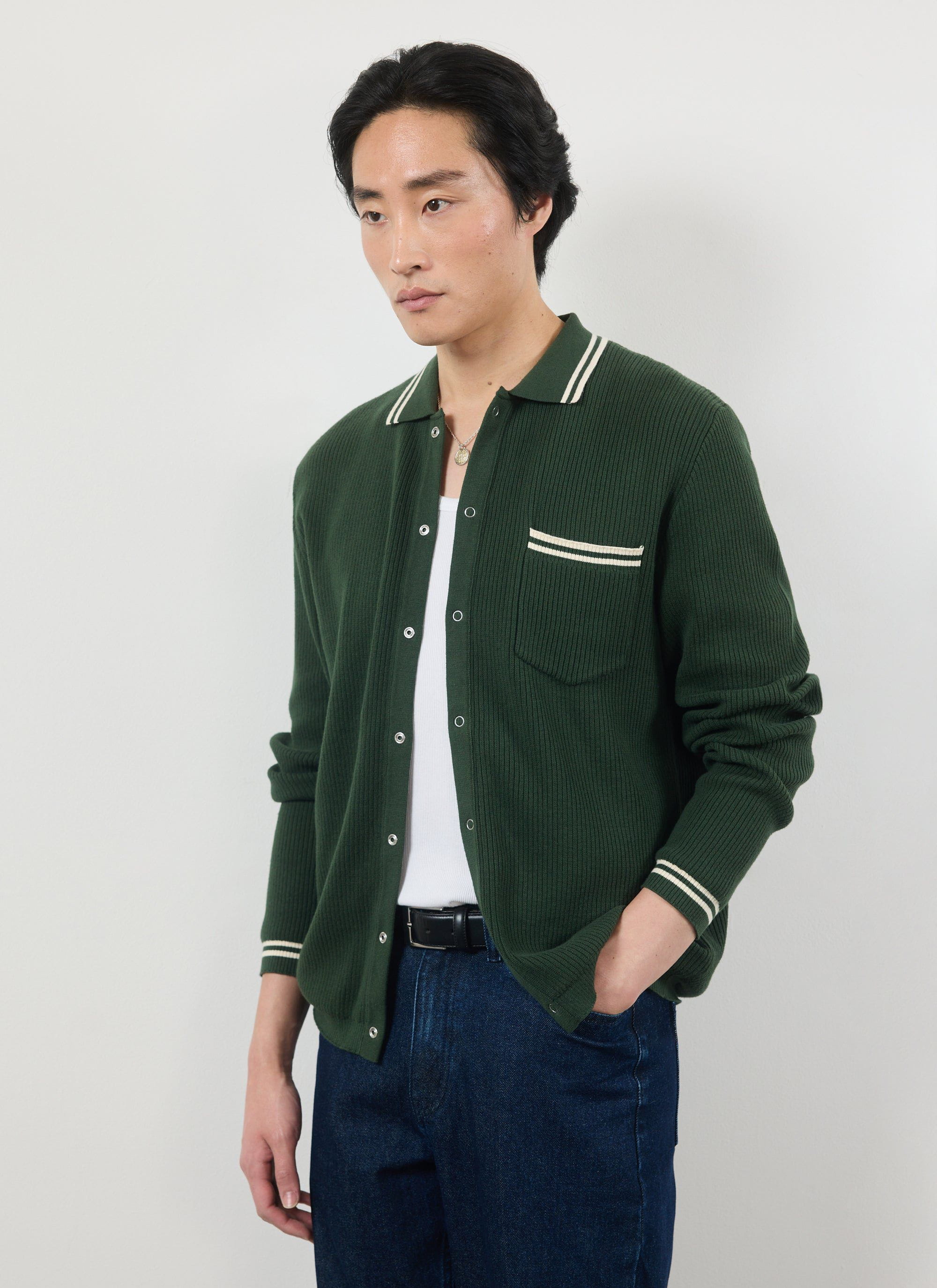 A model wears the Percival Pablo knitted shirt in forest green with white tipping details over a t-shirt and jeans.