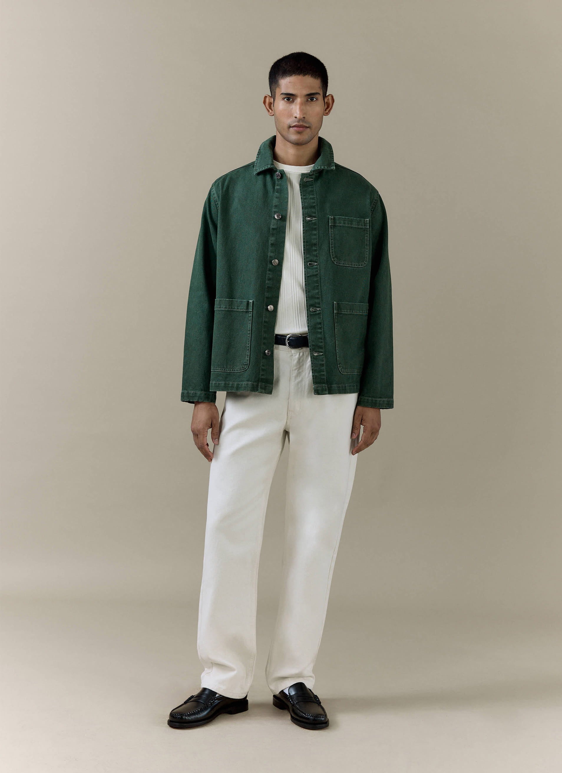 Percival Vintage Wash Oliver Chore Jacket in forest green cotton canvas, styled on a model with white trousers.