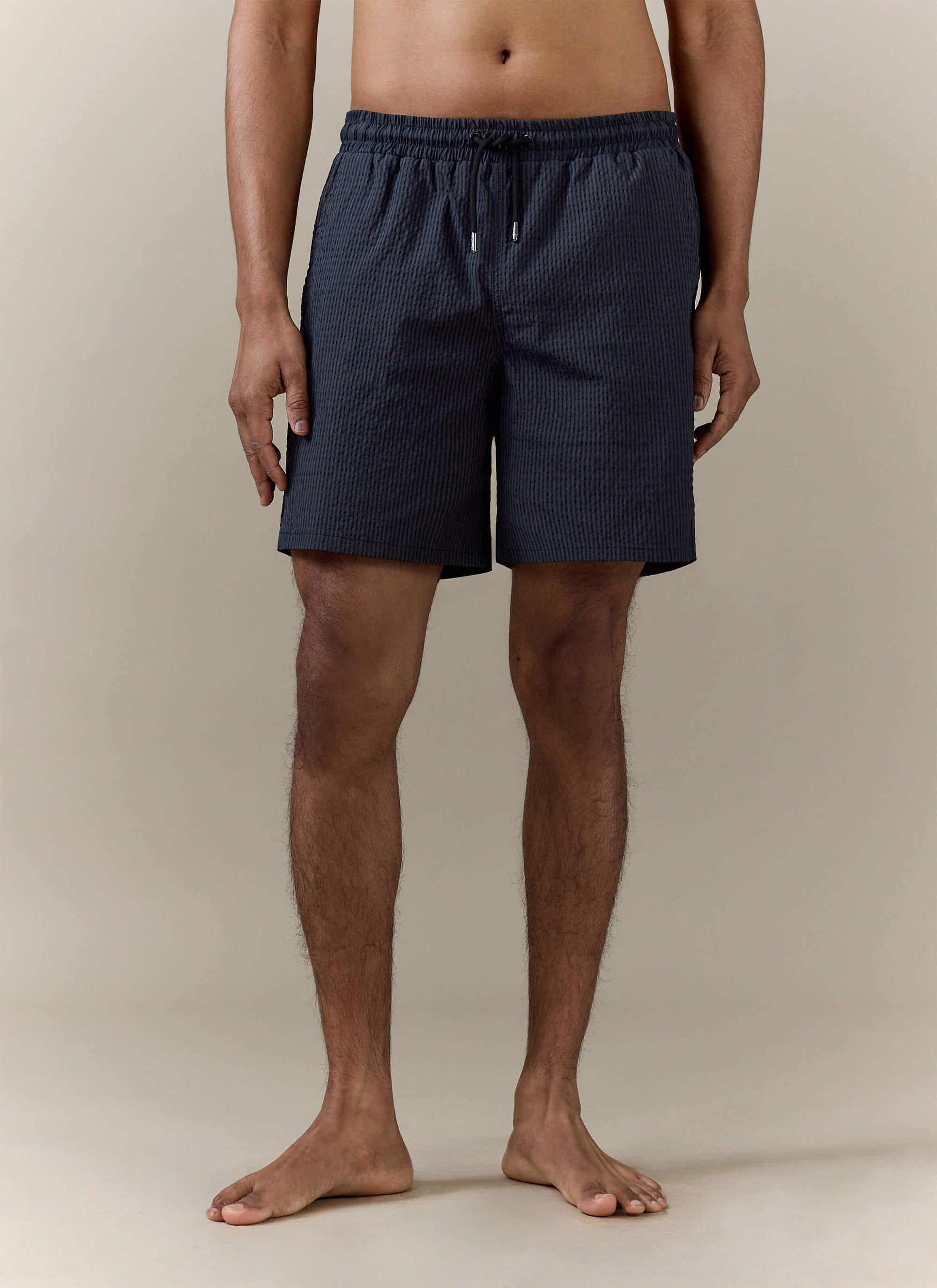 Percival Rowan Seersucker Swim Shorts in navy stripe, featuring a drawstring waist and textured cotton blend fabric.