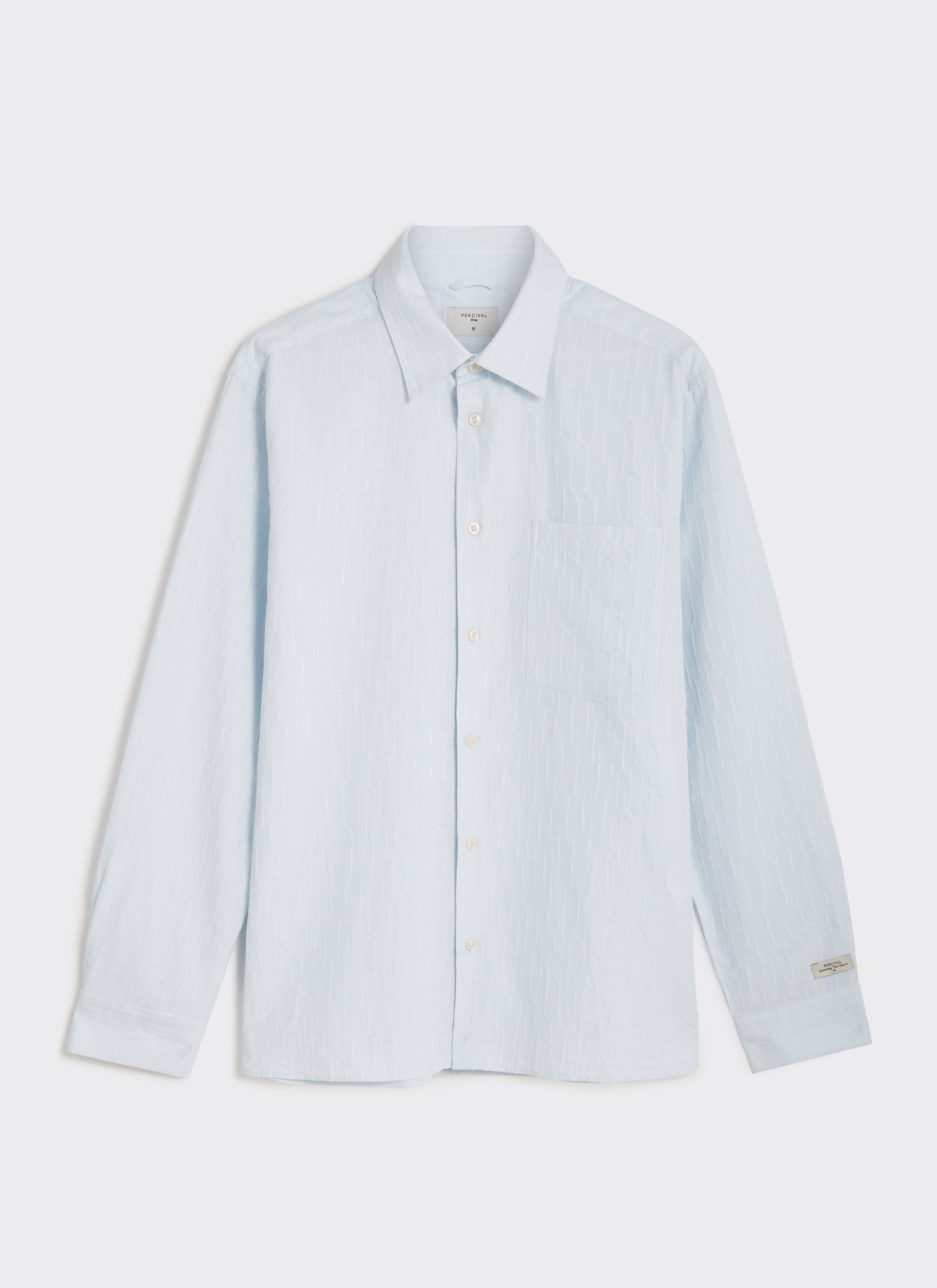 A flat lay of the light blue Percival Paros Pearce long sleeve shirt in textured cotton seersucker fabric.