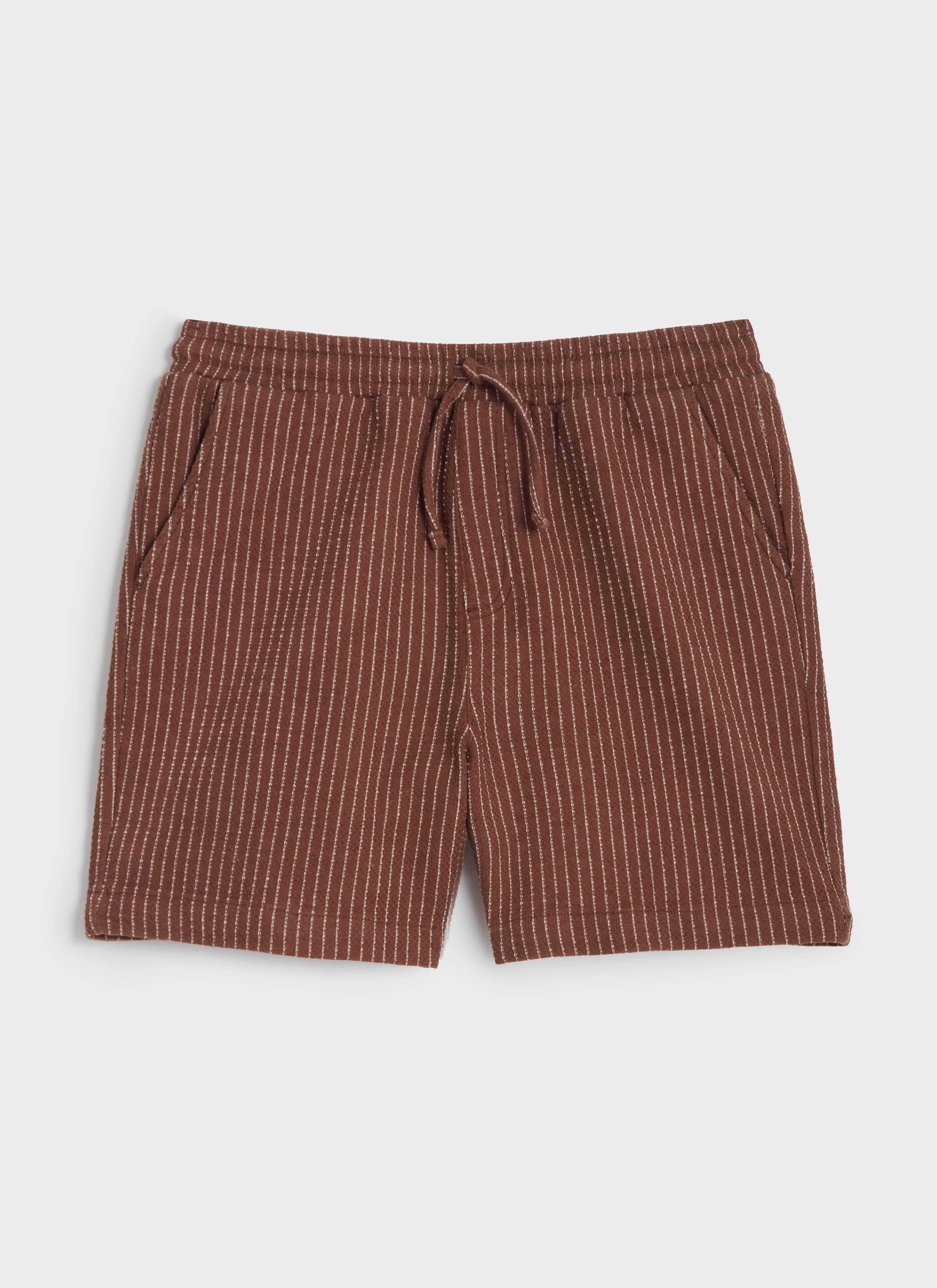 A flat lay of the Percival Sorrento Straight Leg Shorts in brown linen-blend, featuring a white vertical pinstripe pattern.