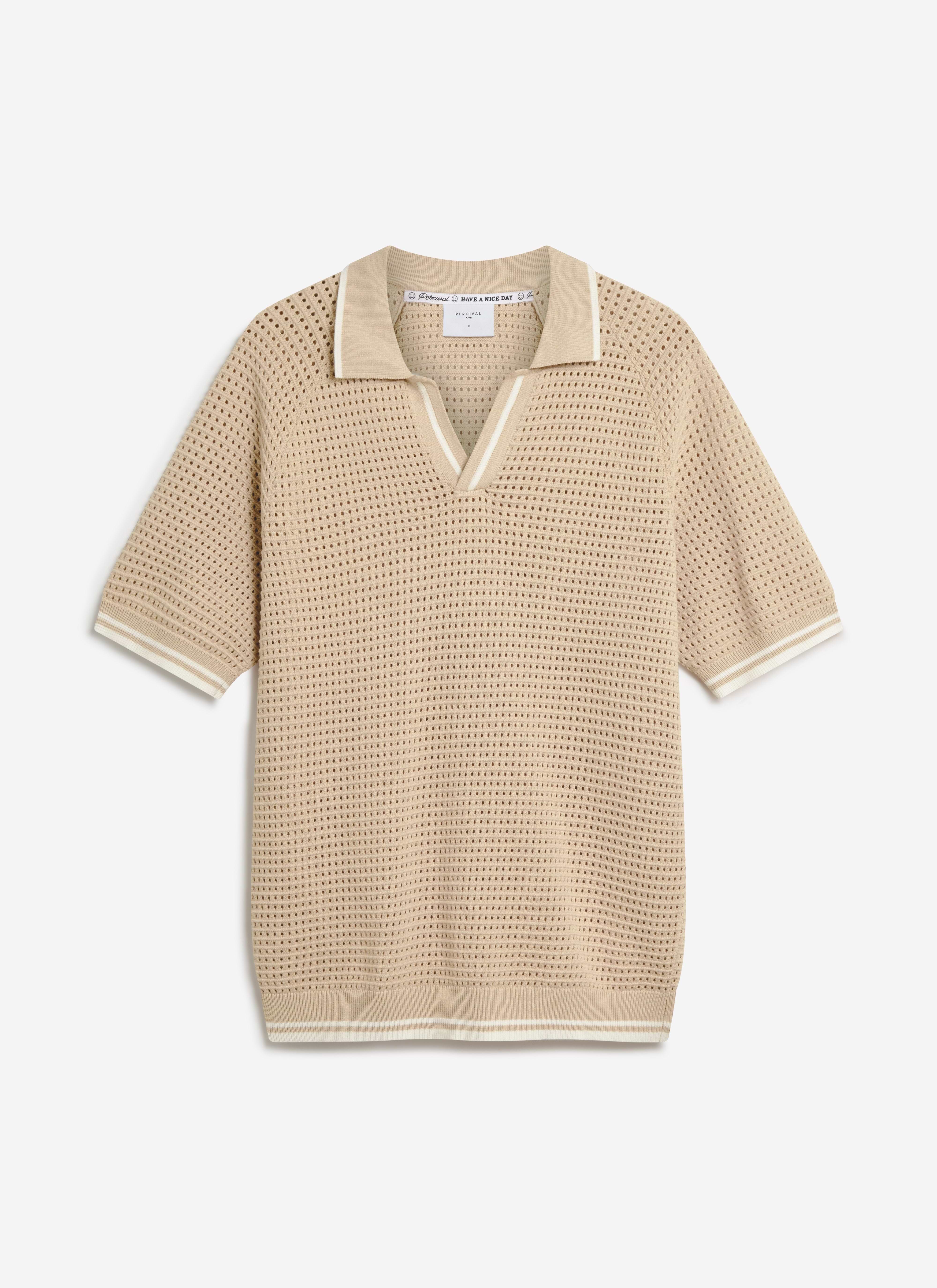 A flat lay of the Tennis Boxy Knitted Polo in ecru by Percival, showing the perforated texture and contrast stripe details.