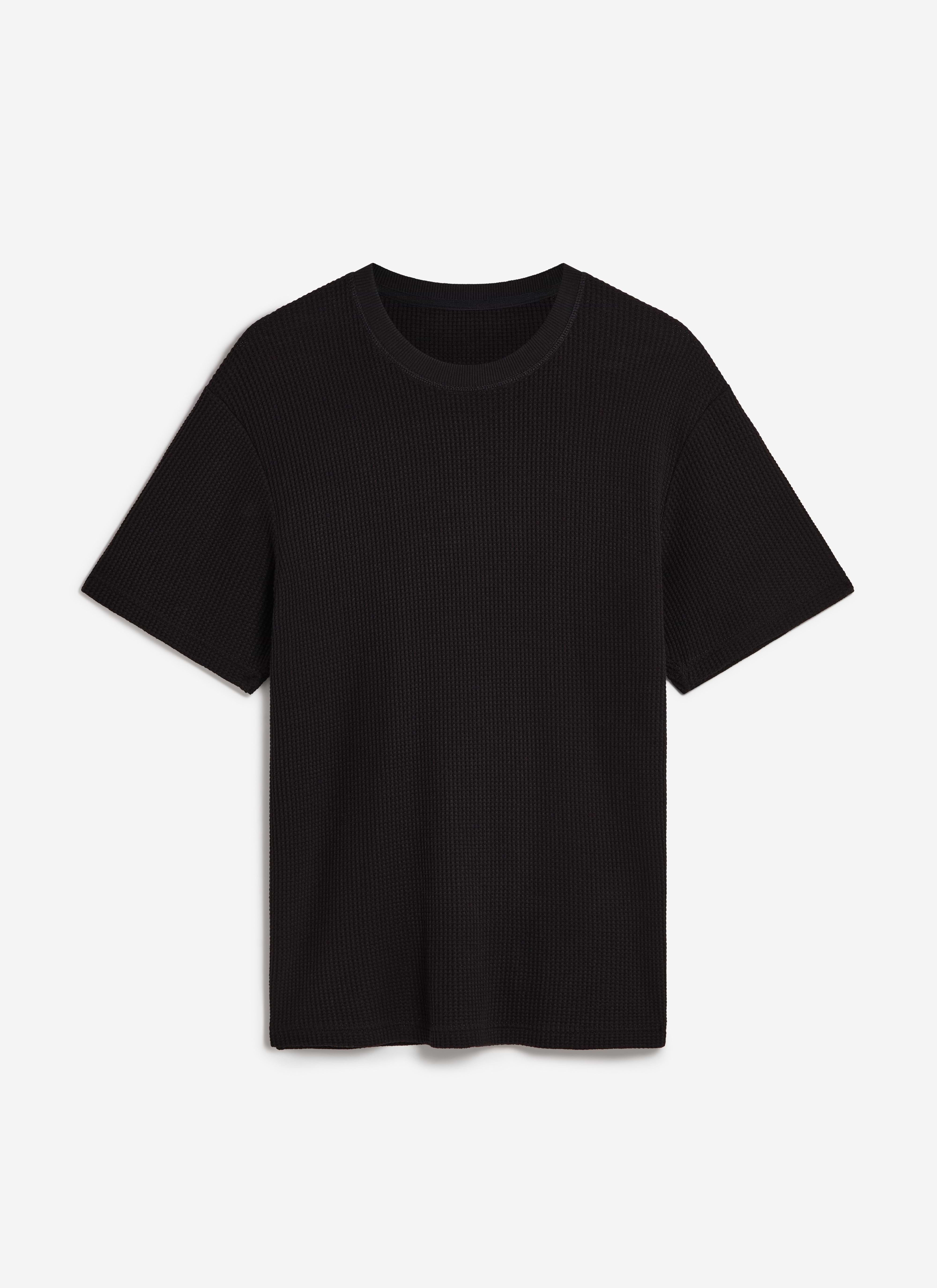 A flat lay of the Percival Waffle Short Sleeve T Shirt in black, showcasing the textured organic cotton waffle knit.