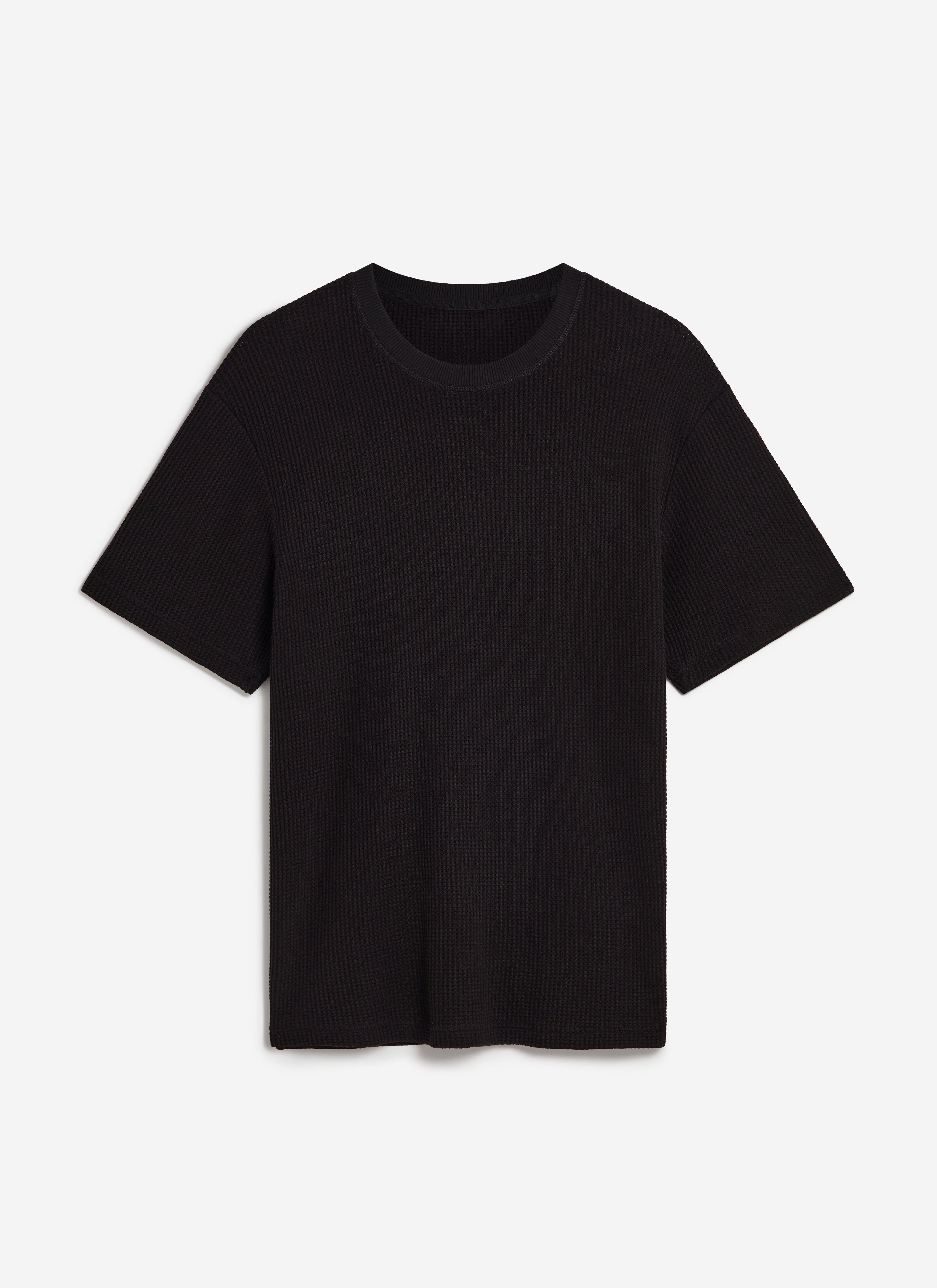 A flat lay of the Percival Waffle Short Sleeve T Shirt in black, showcasing the textured organic cotton waffle knit.