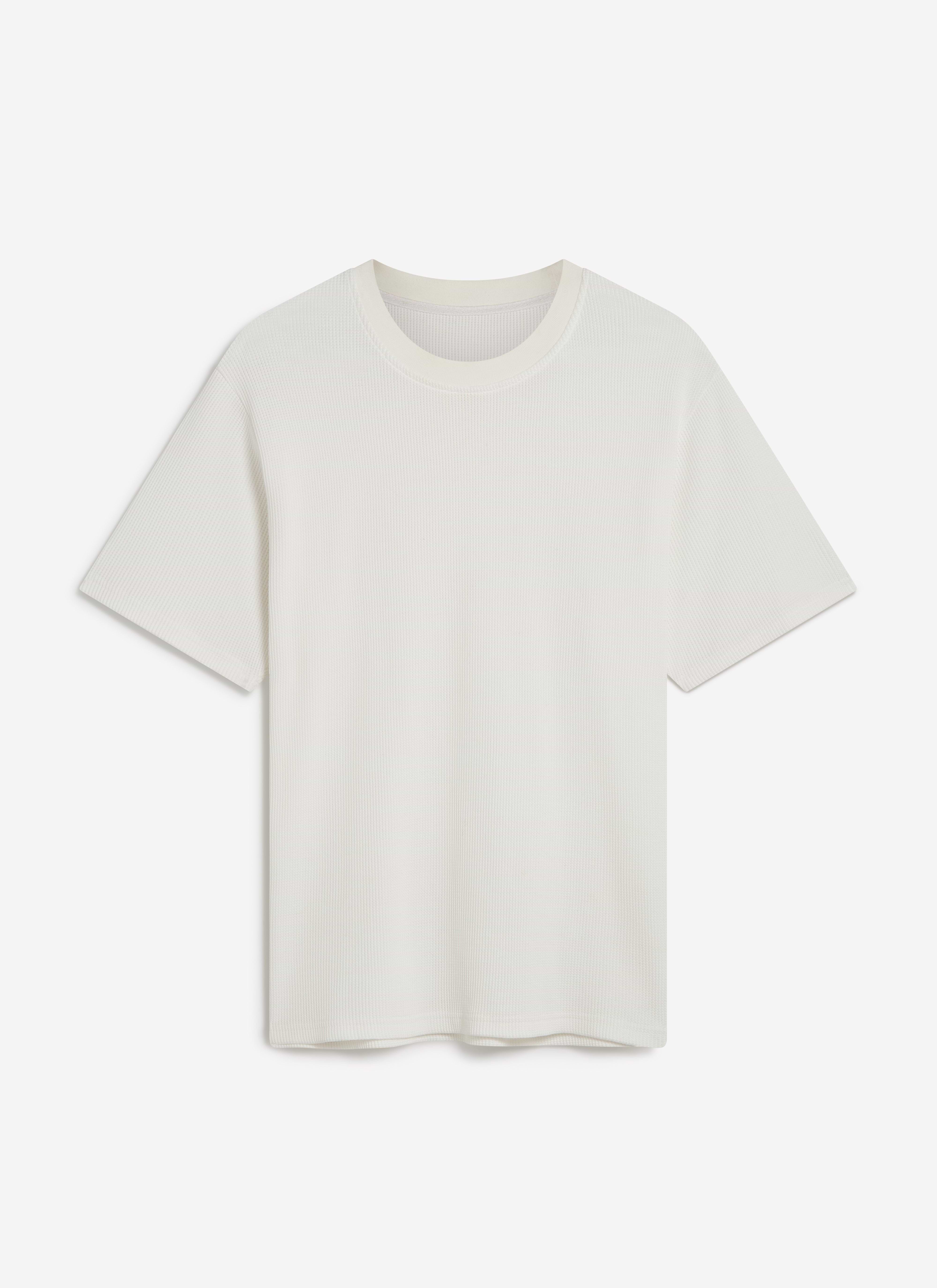 A flat lay of the white Waffle Short Sleeve T Shirt by Percival, showing the soft, textured organic cotton material.