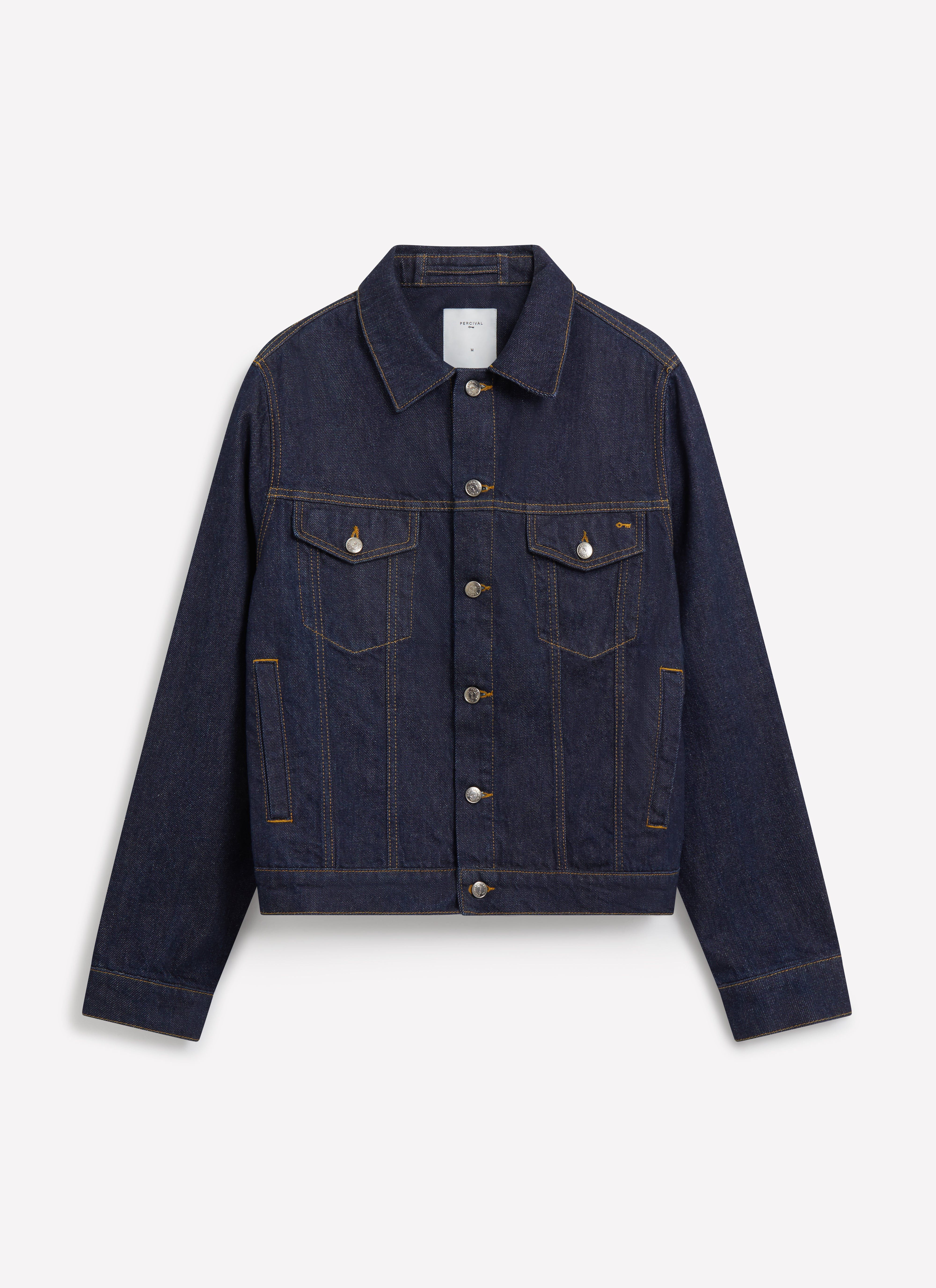 The Percival Western Trucker Jacket in dark indigo denim with contrast stitching, shot flat on a white background.