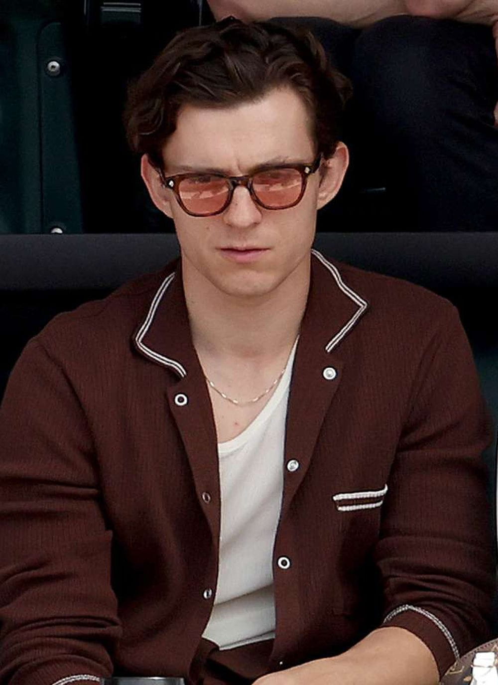 Actor Tom Holland wearing the brown long sleeve Pablo knitted shirt from Percival over a white t-shirt.