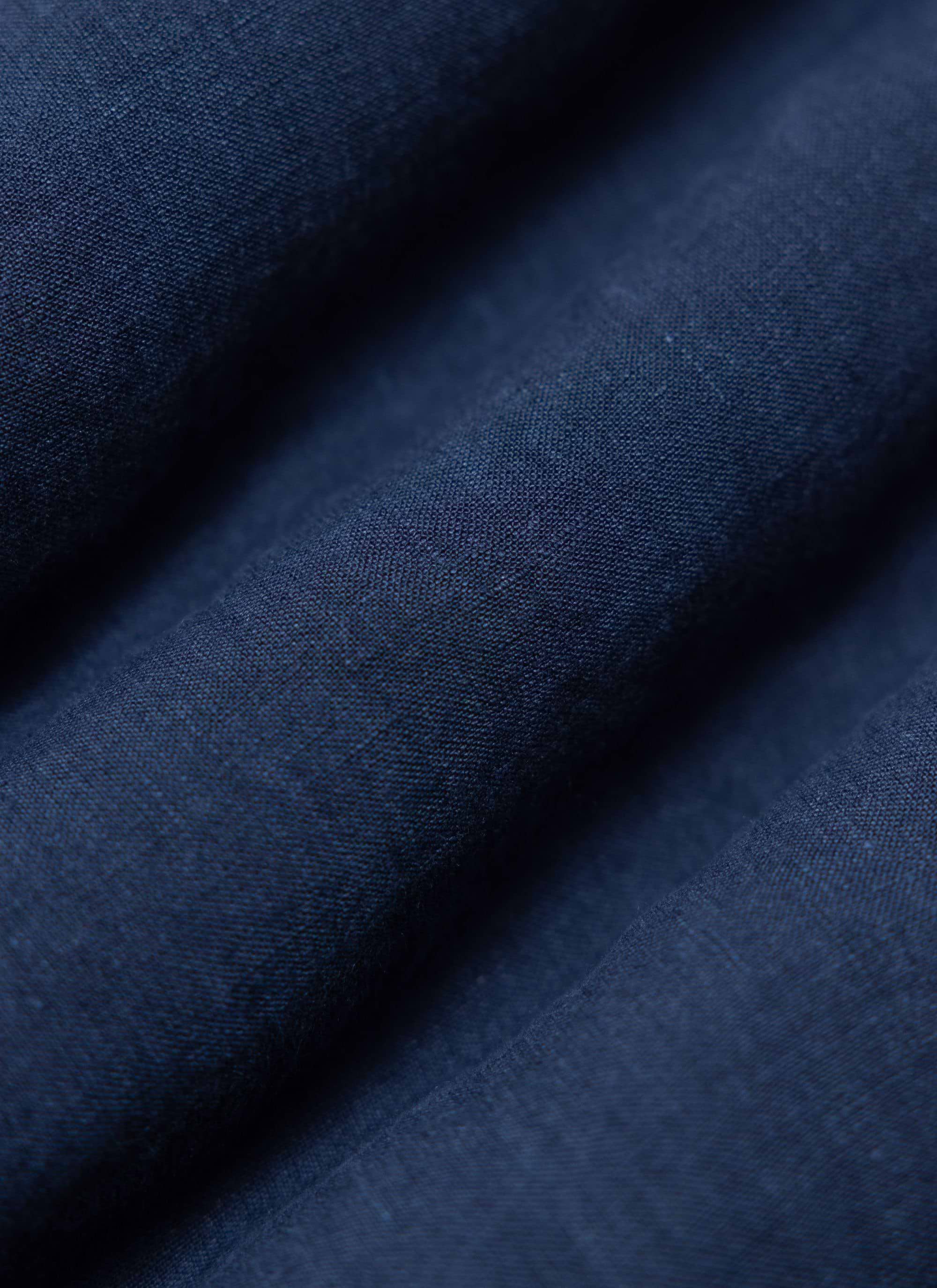 A close-up of the Percival Pearce Shirt in navy, highlighting the texture and breathable weave of the 100% linen fabric.