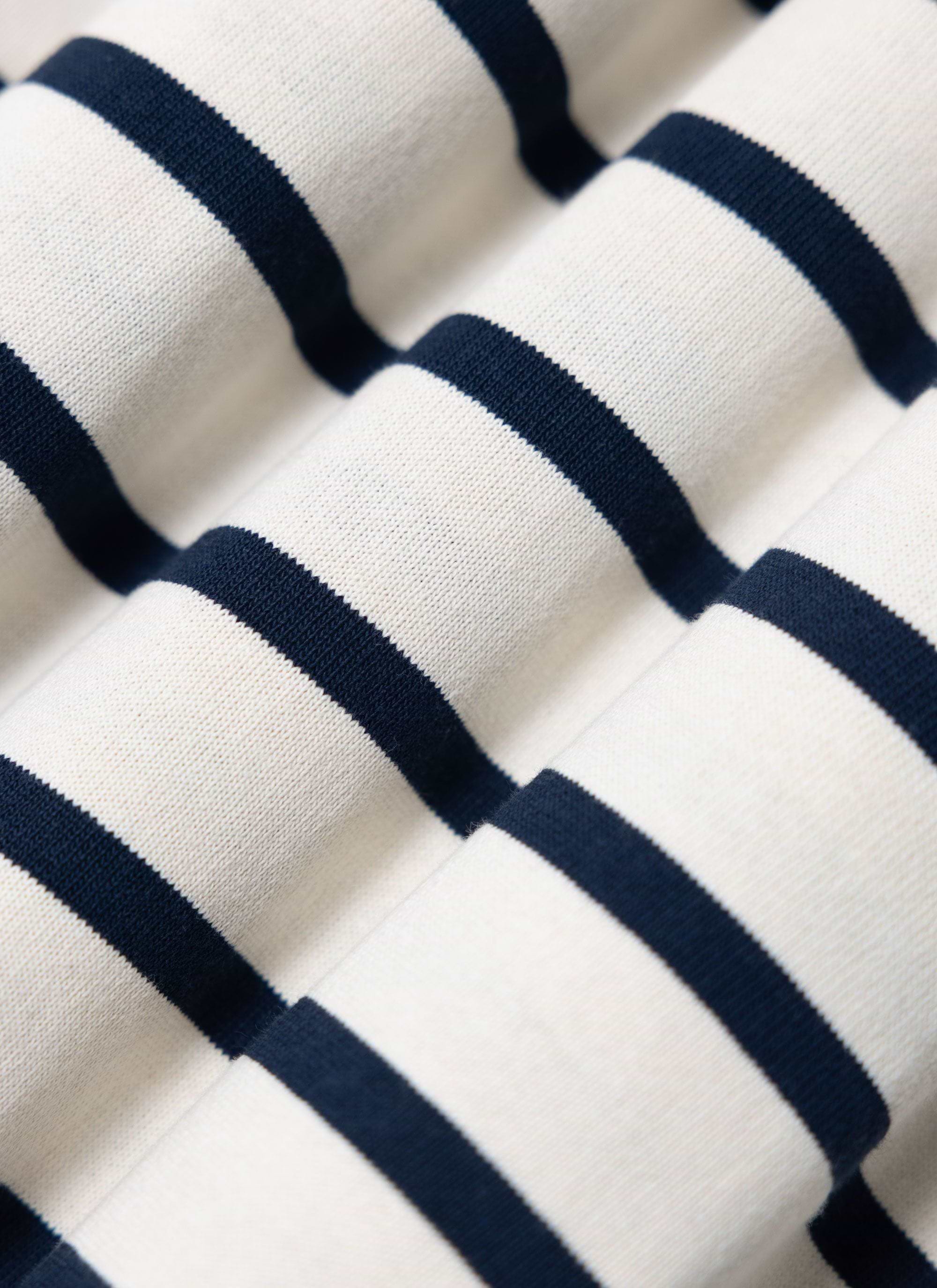 A close-up detail shot of the Percival Breton Stripe T-shirt, showing the navy stripes on the ecru organic cotton fabric.