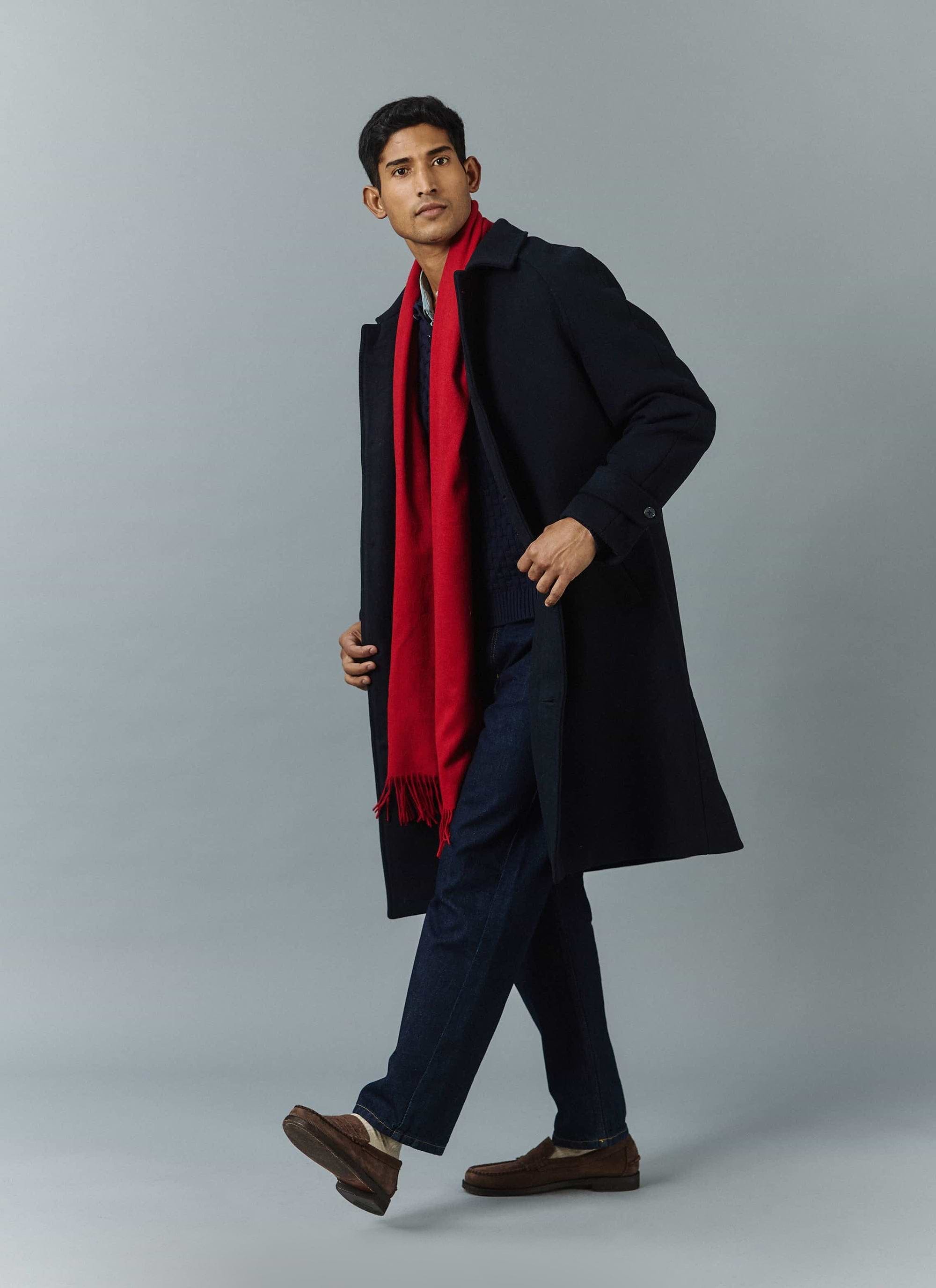 A model wears the Percival navy wool car coat and red Tolkein scarf, layered over a jumper and dark jeans.